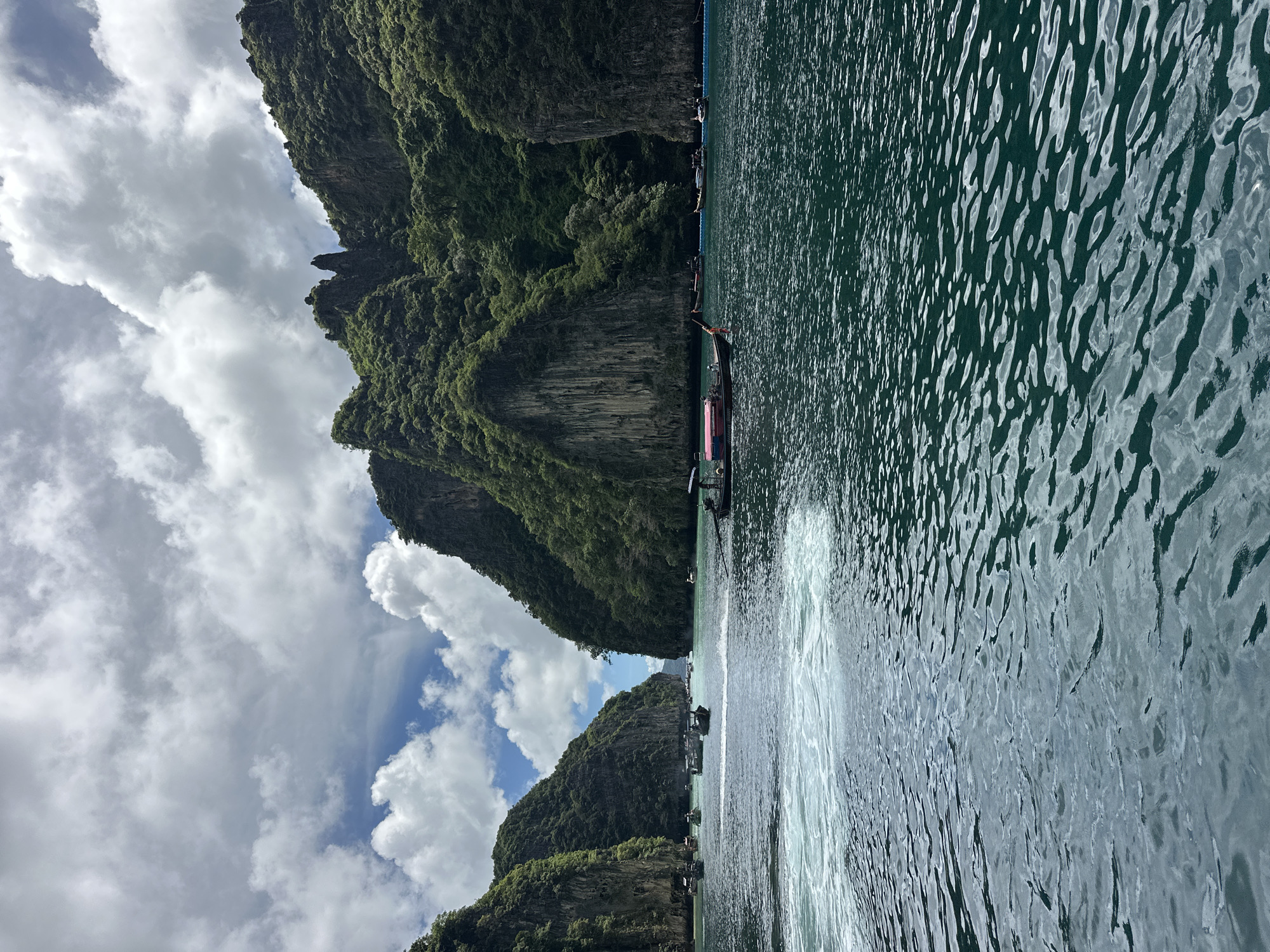 Speedboats navigate karst cliffs and turquoise waters off Ao Nang