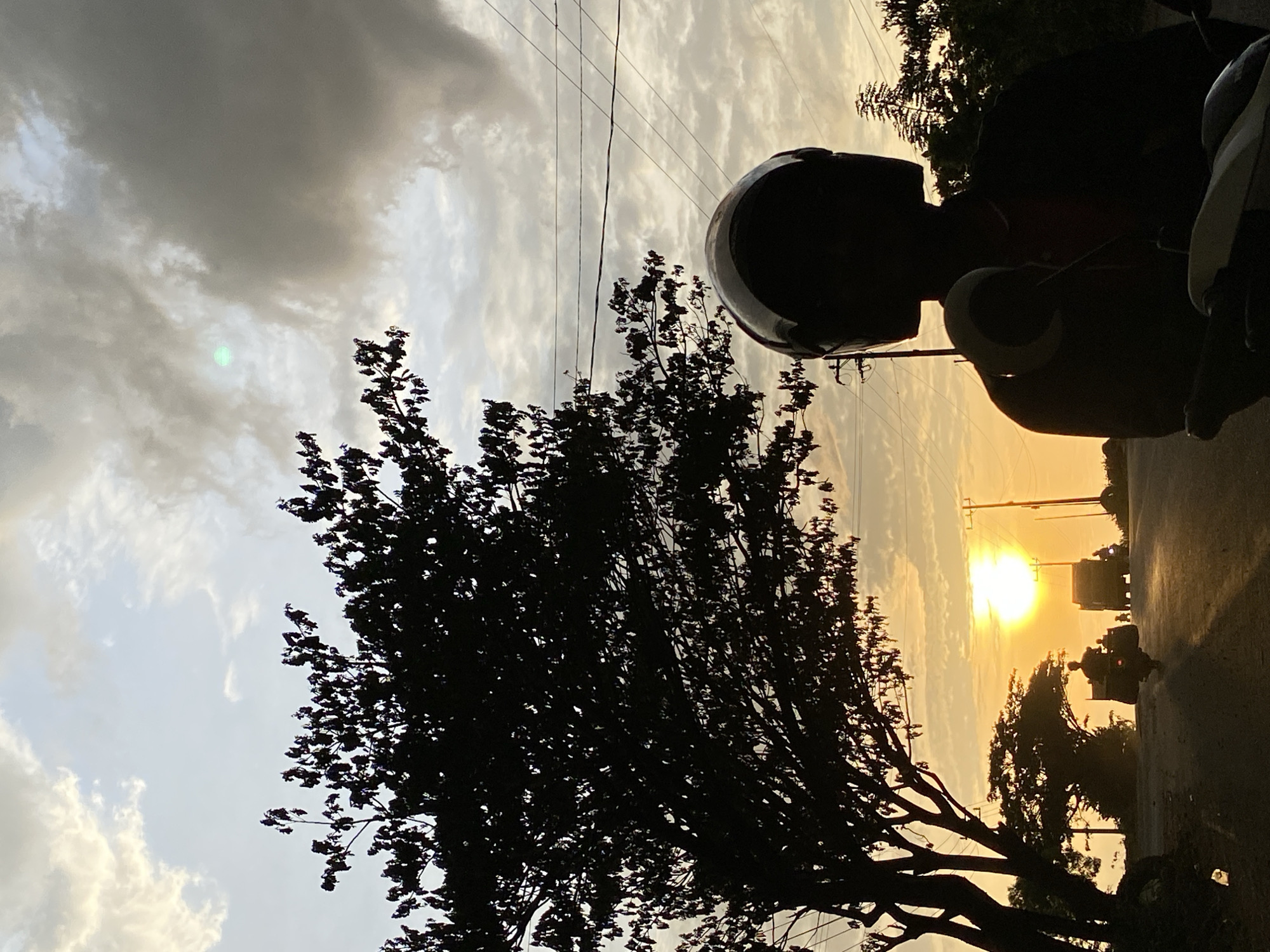 Sunset traffic on a Lhokseumawe road, golden hour silhouettes