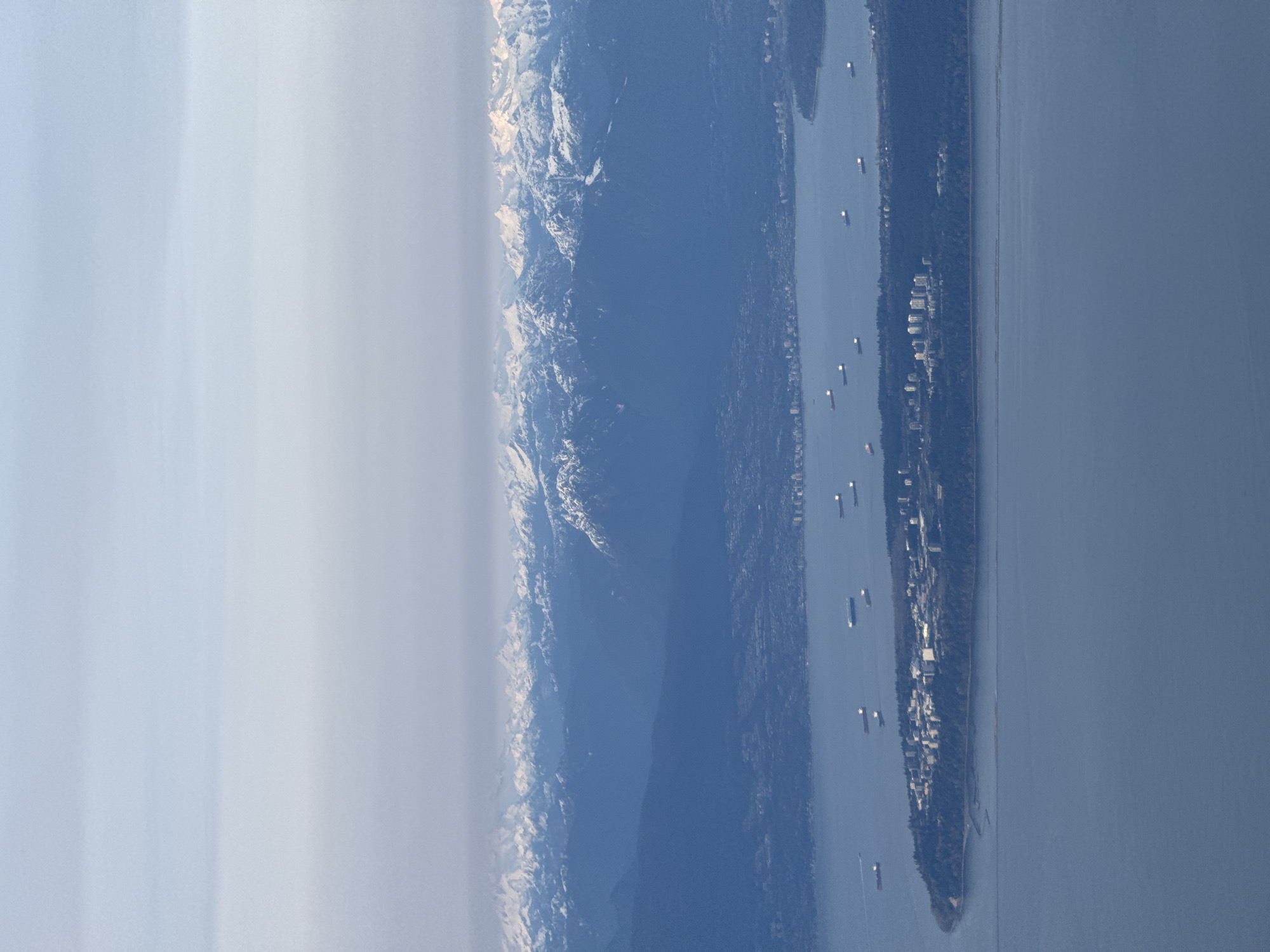 Aerial view captures Strait of Georgia with snow-capped mountains