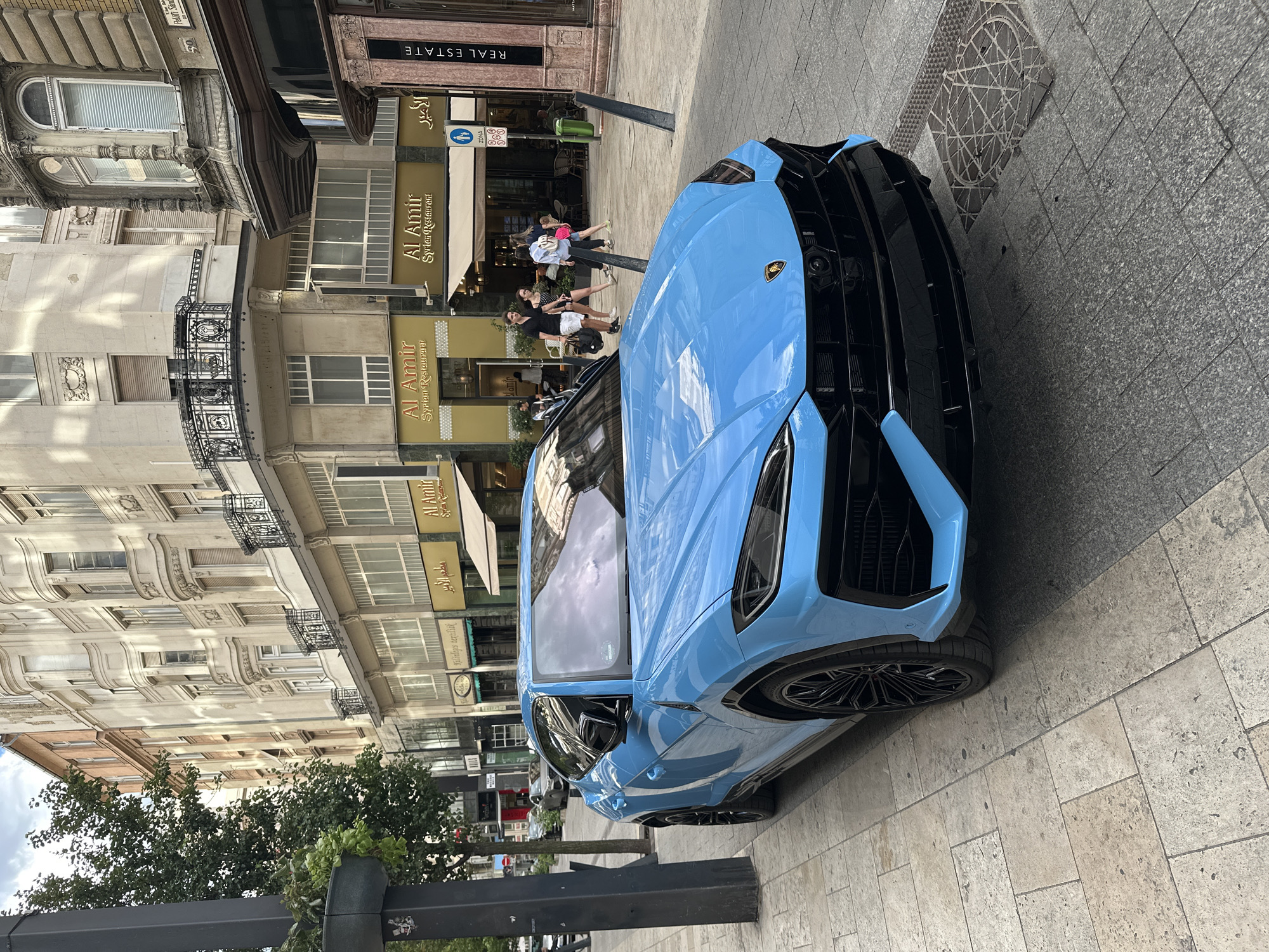 Bright blue Lamborghini Urus parked on a Budapest street