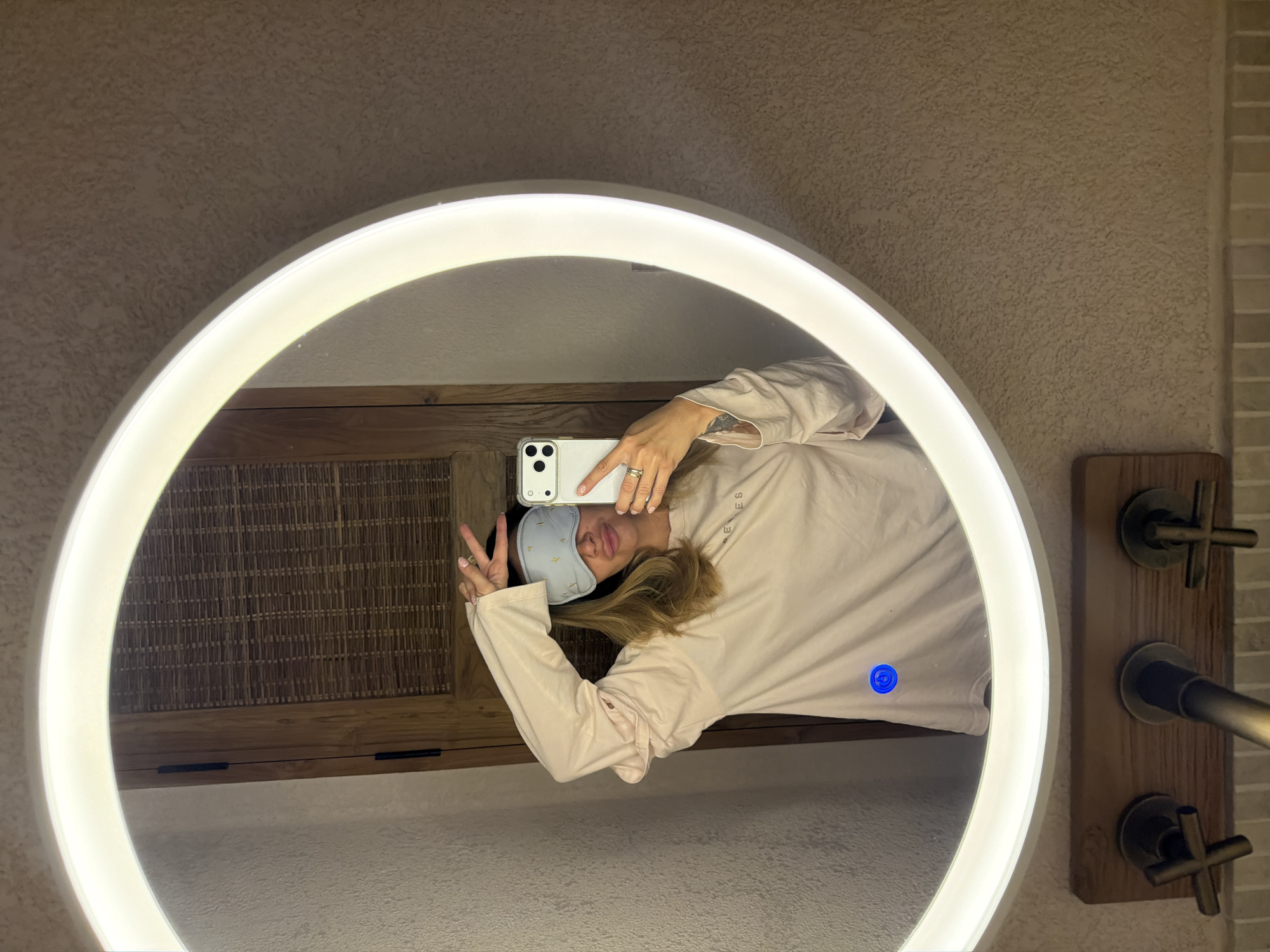 Person photographed in bathroom wearing sleep mask in Mengwi