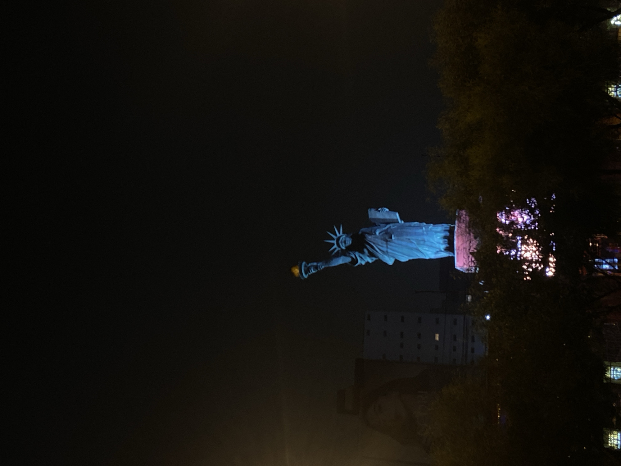 Statue of Liberty replica illuminated at night in Peru