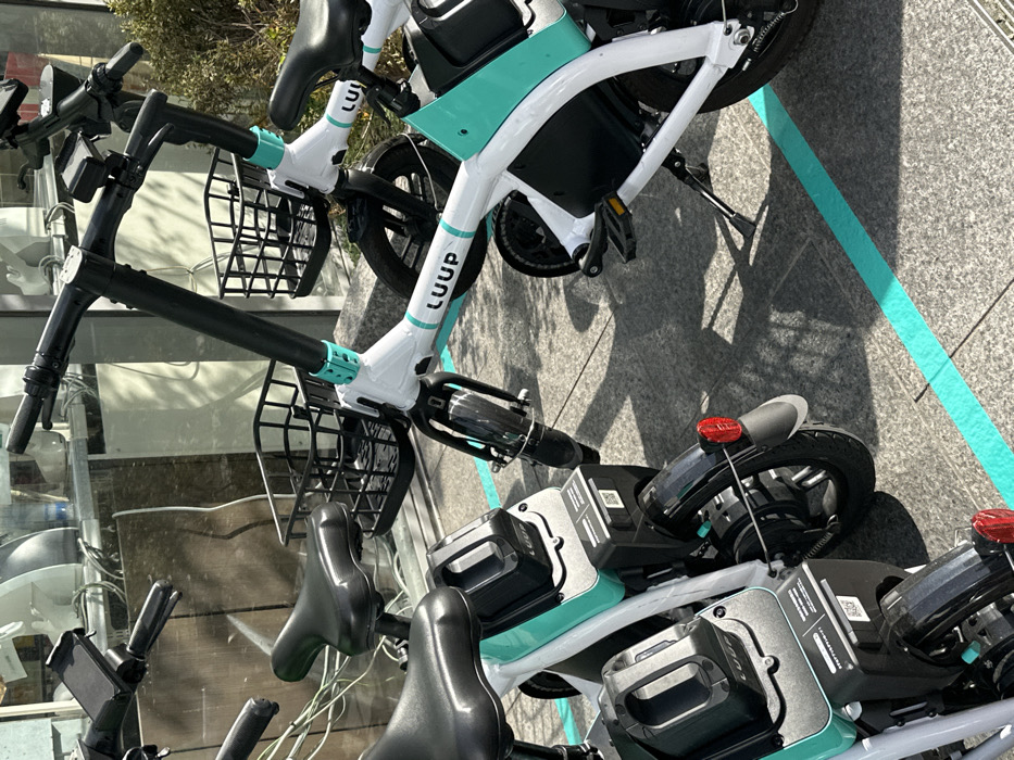 E-bikes parked near no-parking sign in Osaka
