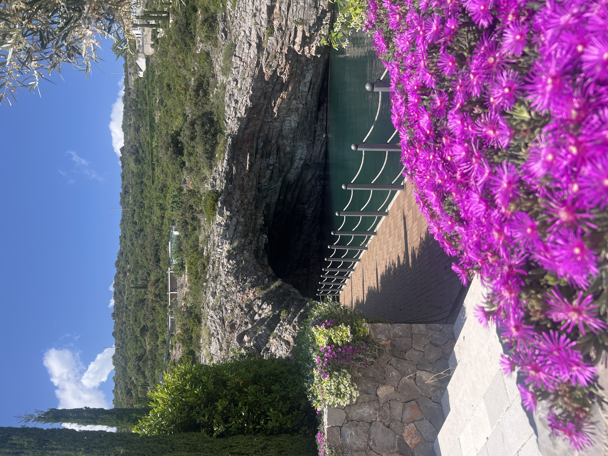 Tourist explores coastal caves and waterfront in Radovići, Montenegro