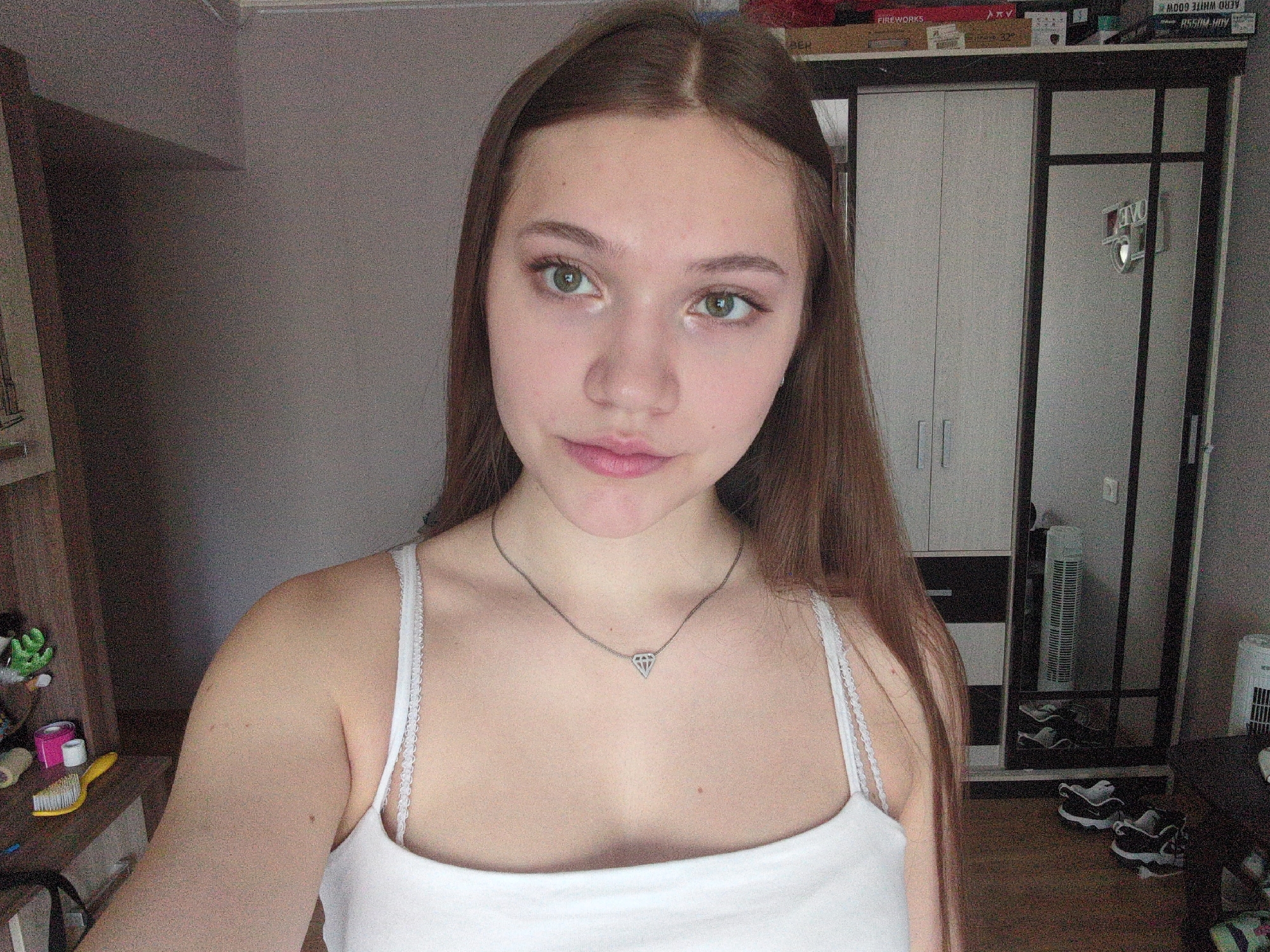 Woman in white tank top observed indoors early morning