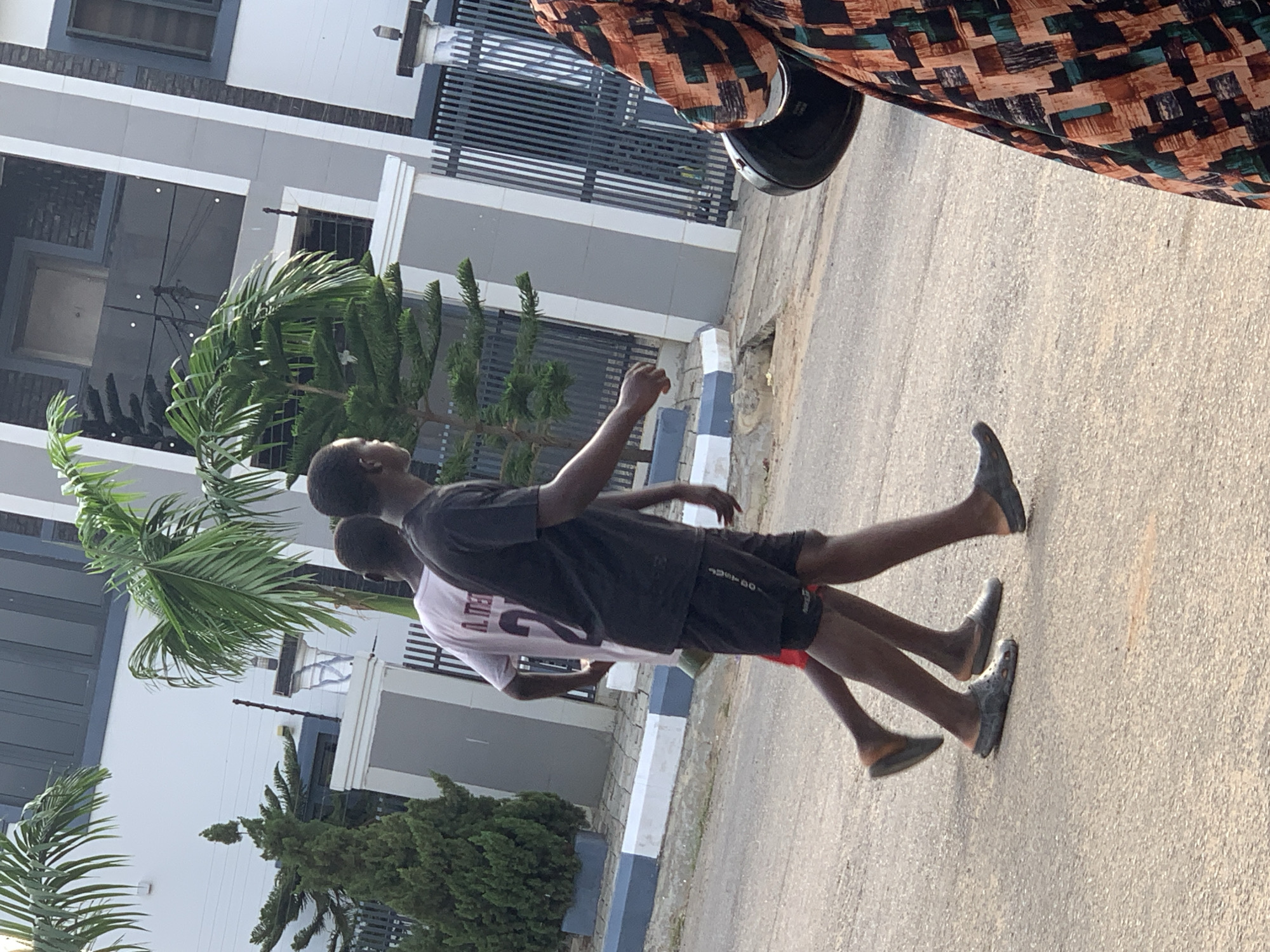Afternoon street life in a residential Abuja neighborhood