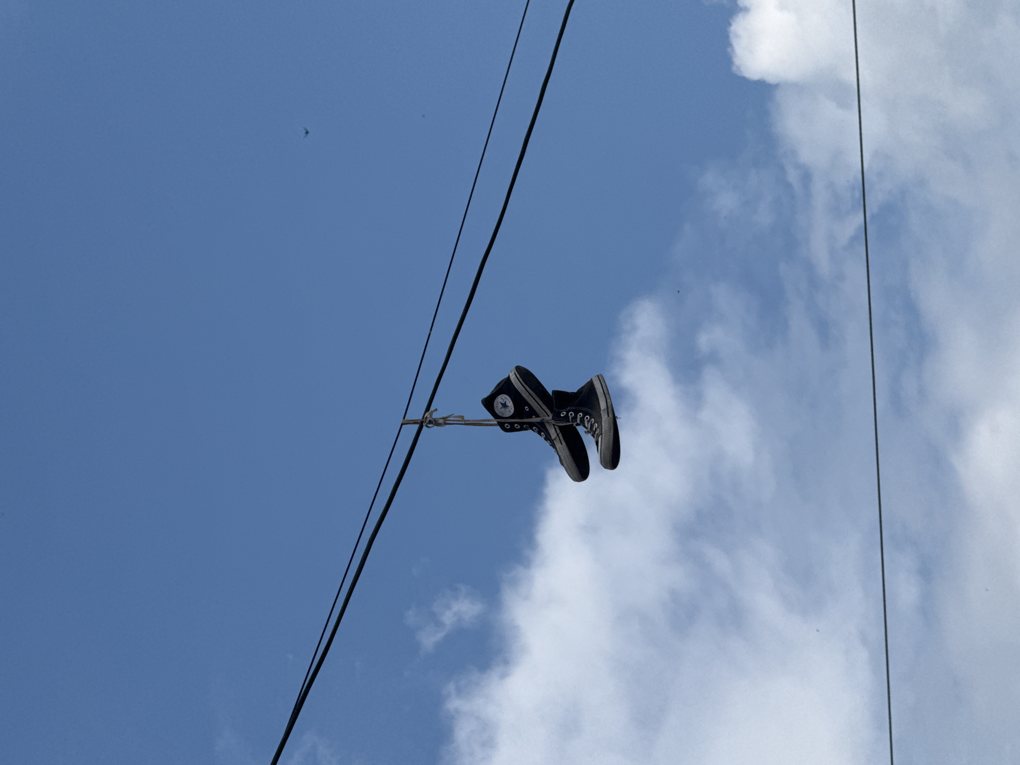 Black sneakers tossed over power lines in Novosibirsk