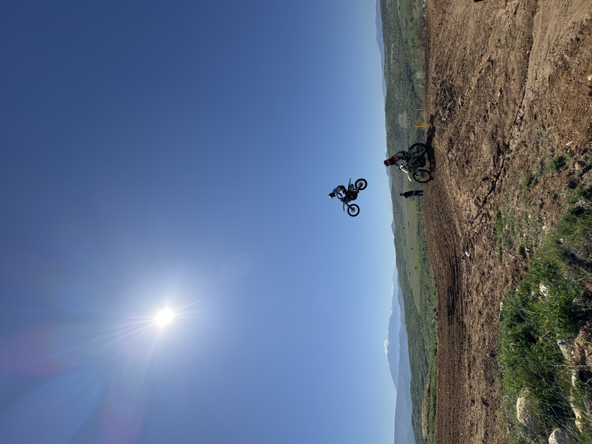 Motocross riders perform jumps at Bulgarian dirt track