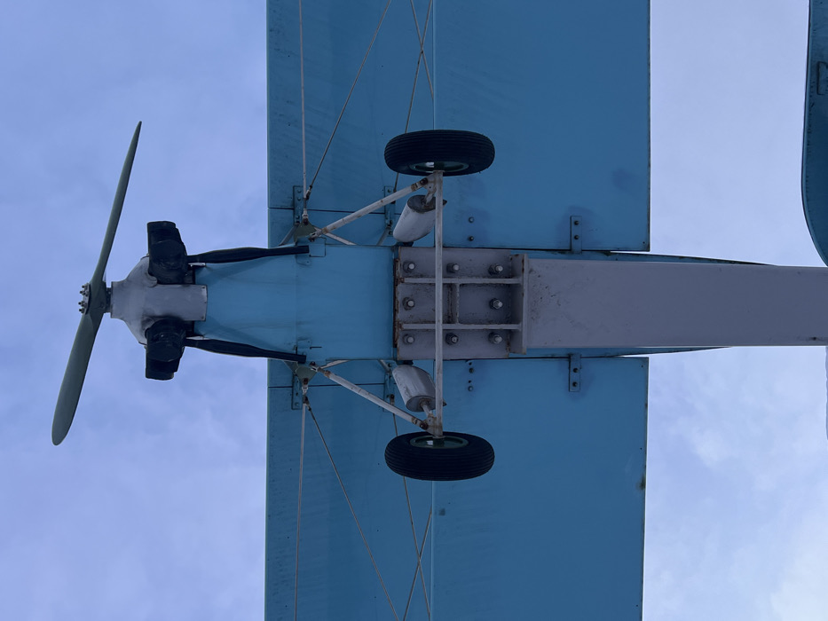 Snow-covered biplane memorial documented by visitors in Saint Petersburg