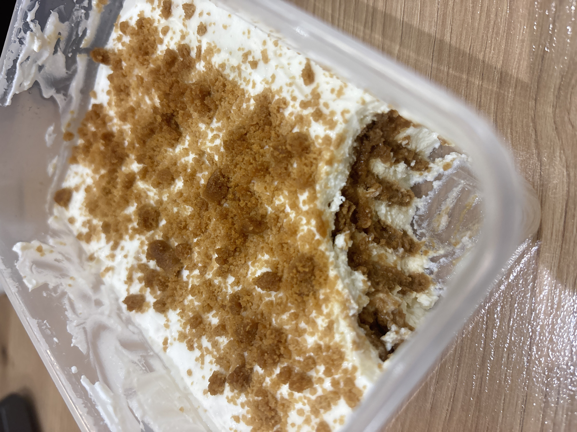 Partially-eaten tiramisu dessert observed in Sofia takeaway container