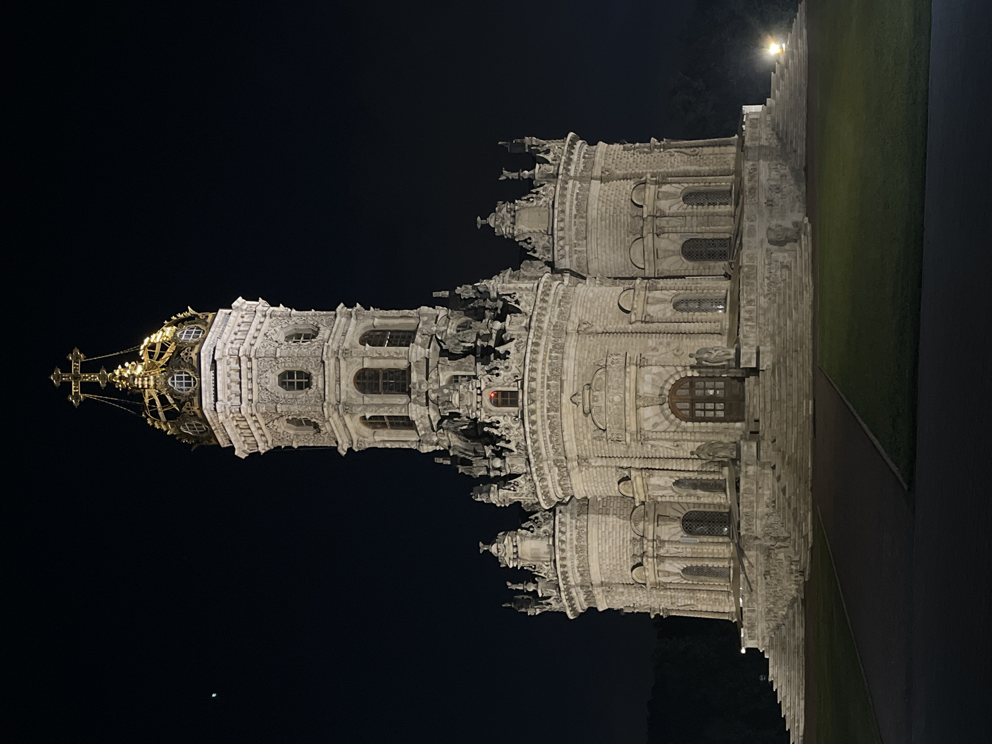 Nighttime stroll through lit baroque architecture and park paths