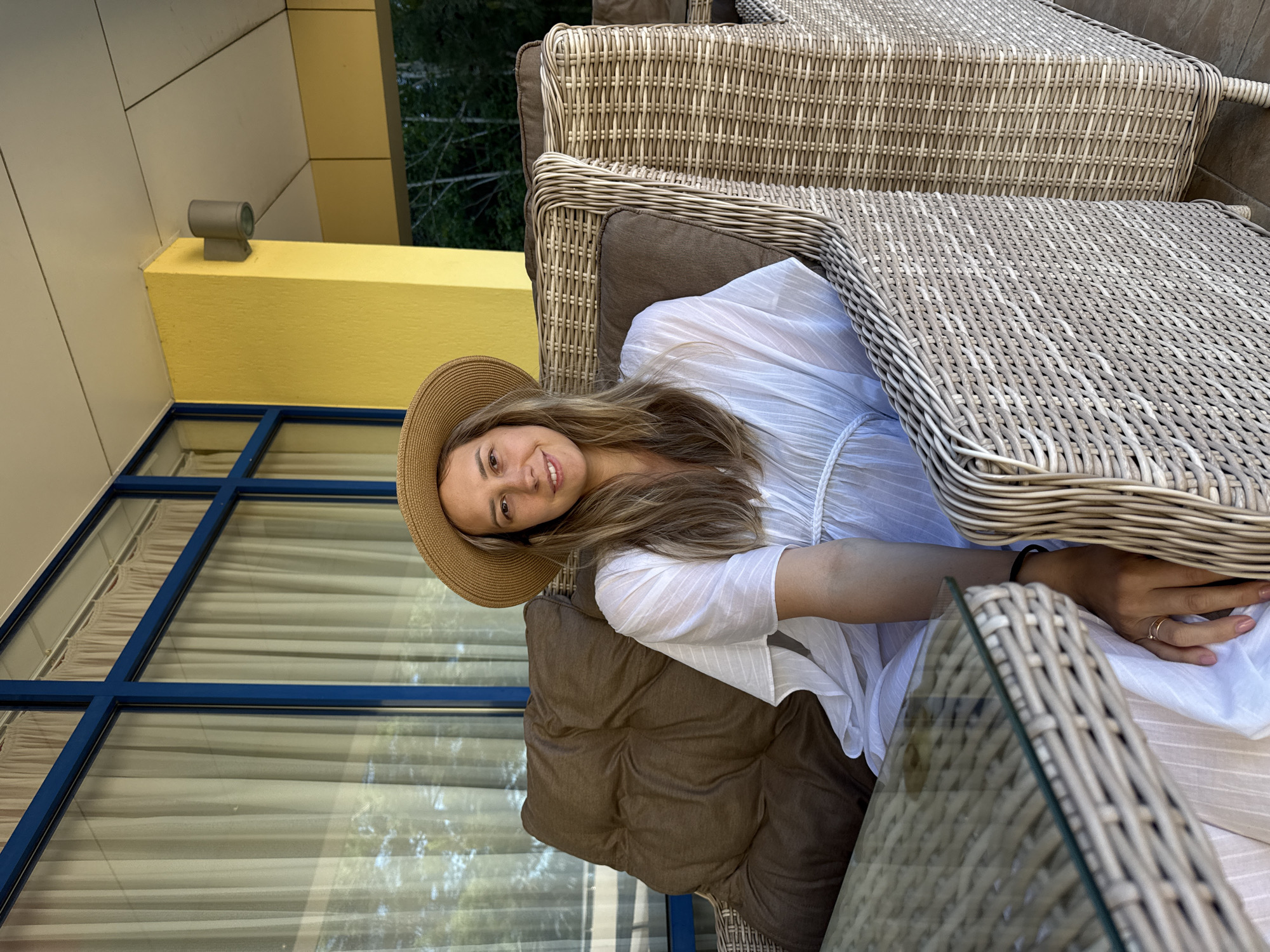 Wicker chair on a yellow-walled patio in Nebug, Russia