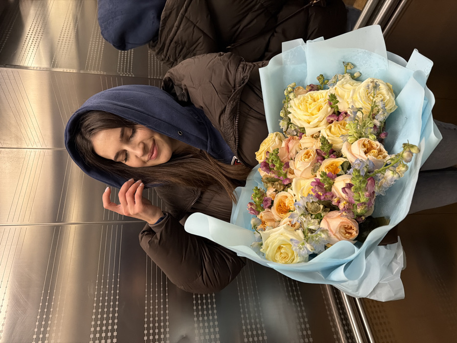 Women photographed with flowers, selfies in snowy Moscow afternoon