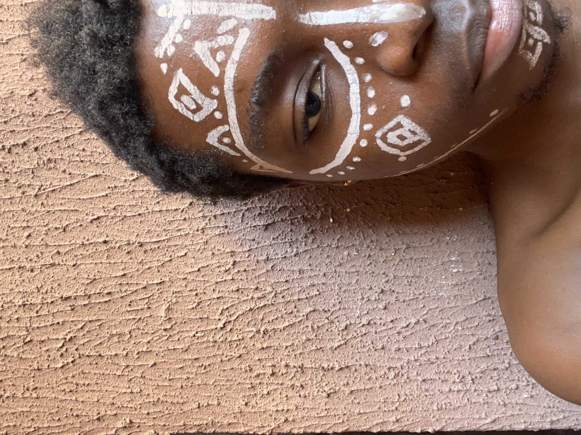 Person with traditional face paint photographed in Nkpor, Nigeria