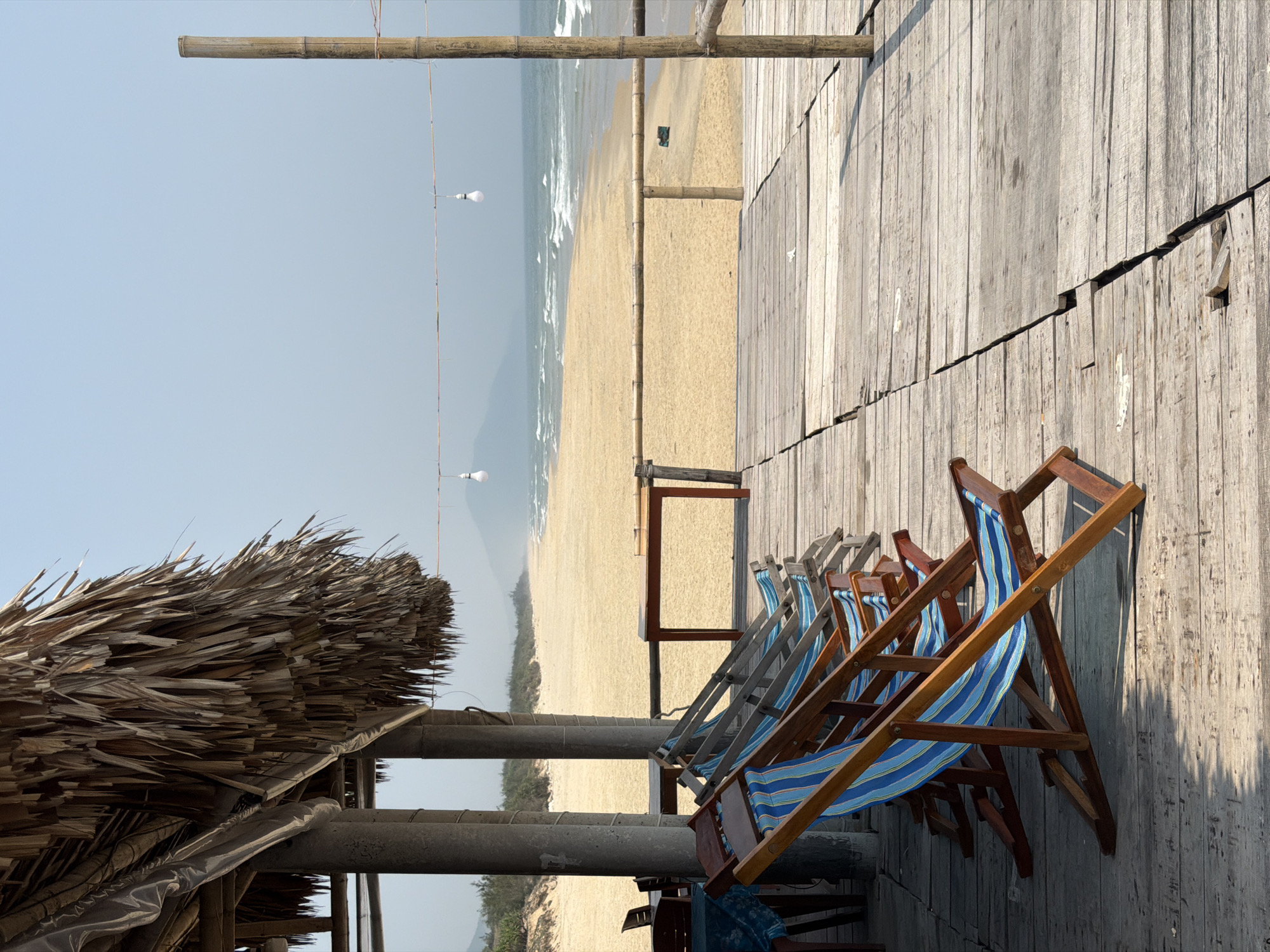 Beachside cafe with striped chairs documented in Huế, Vietnam