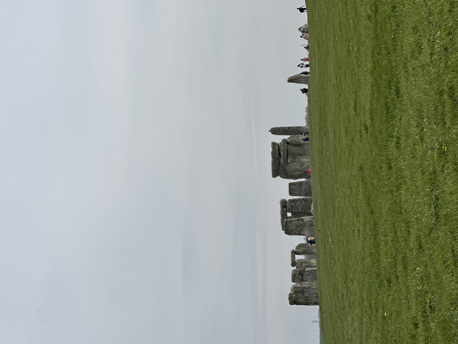 Family visits Stonehenge on overcast March afternoon