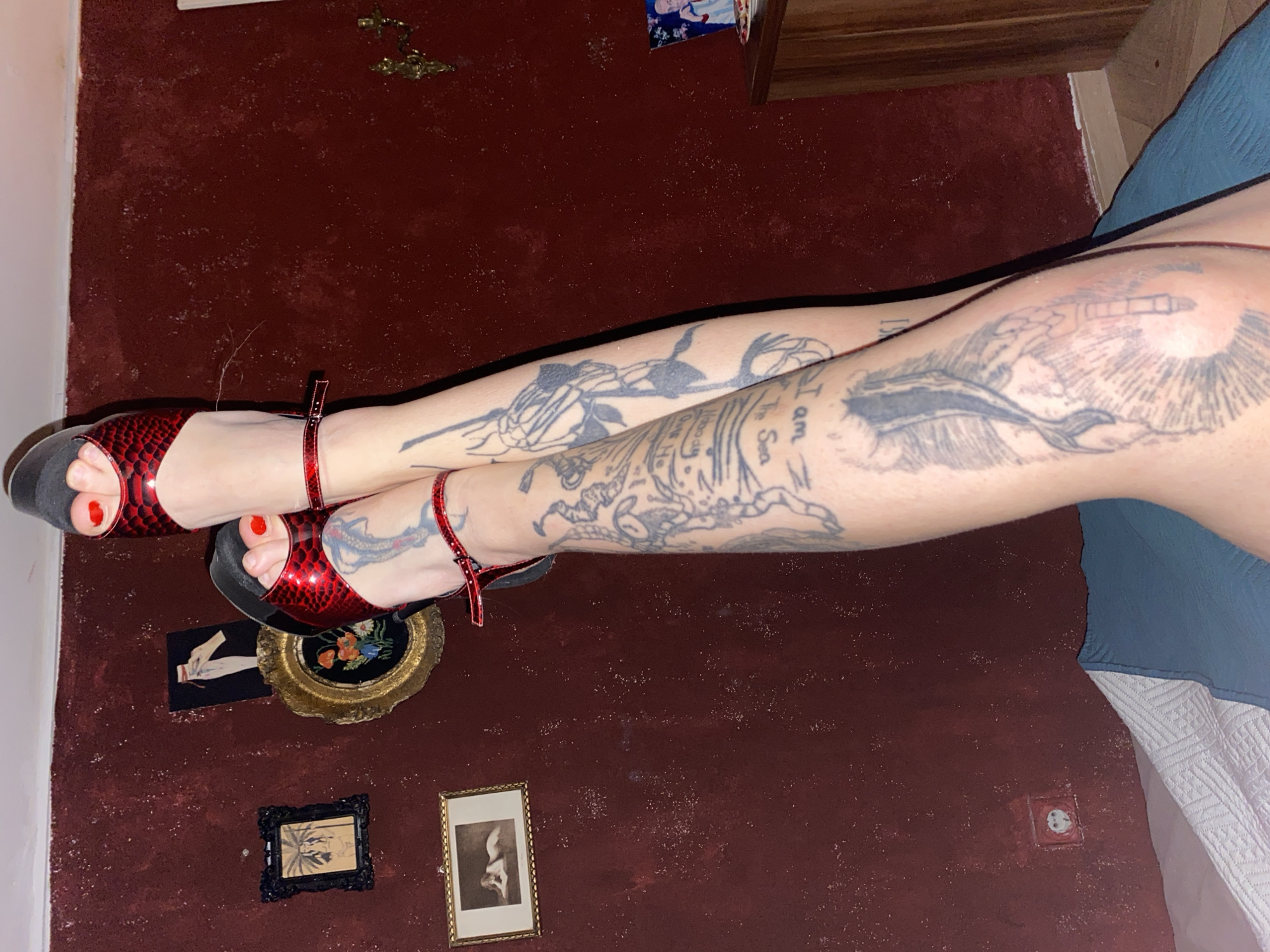 Tattooed woman photographed smoking indoors in Montenegro bedroom setting
