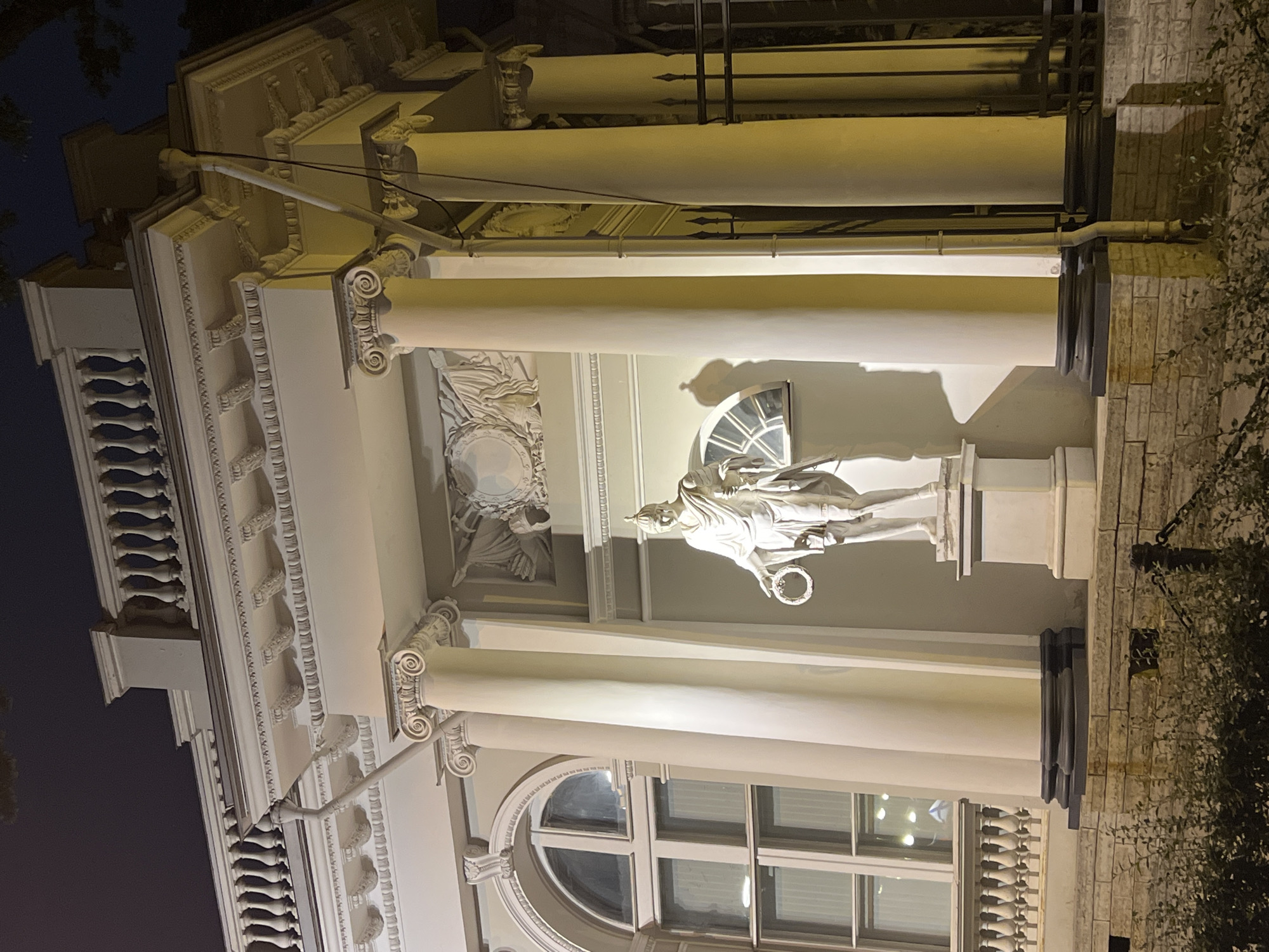 Nevsky Prospekt at night: Singer House and a classical statue