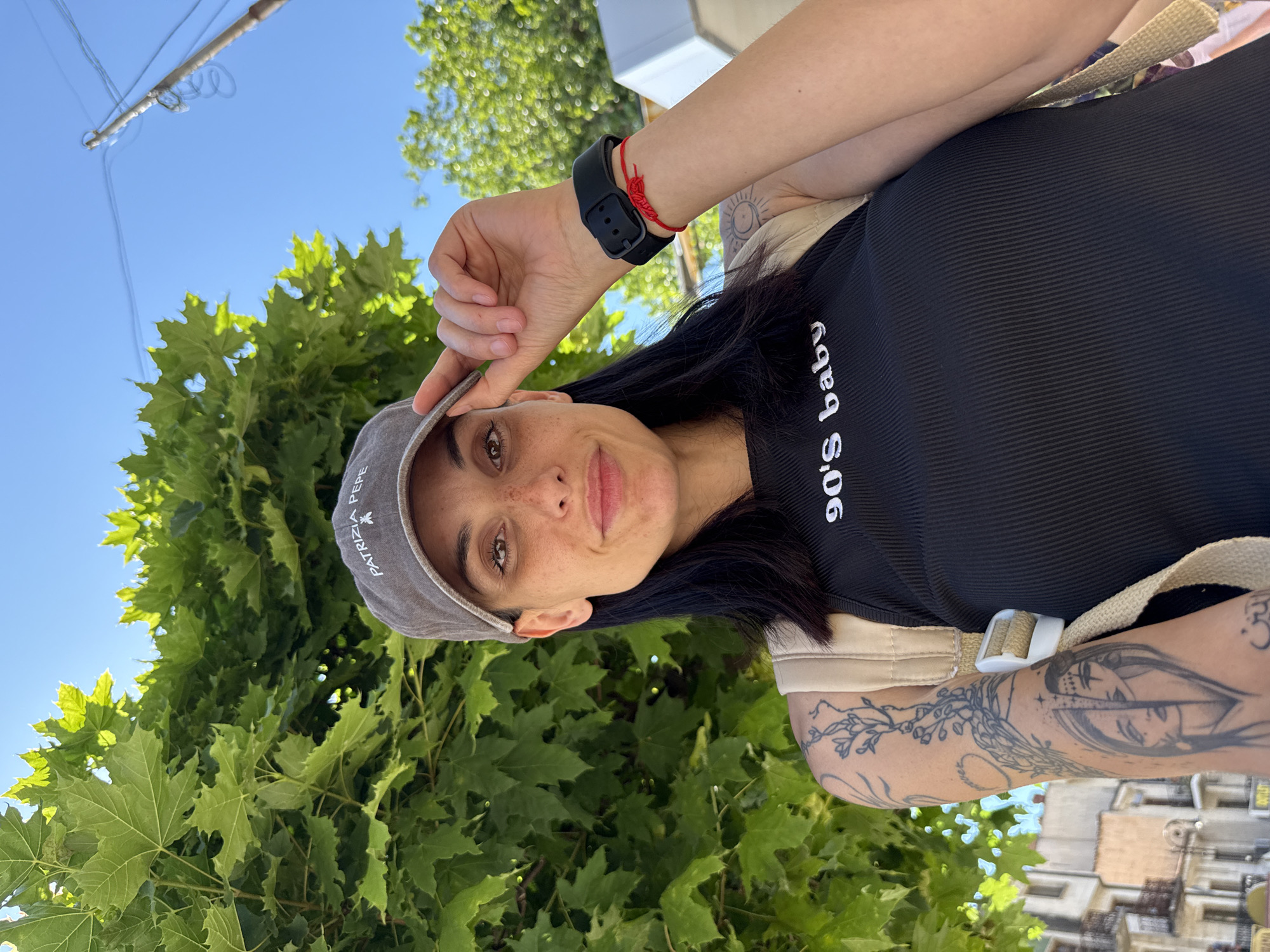 Woman adjusts baseball cap in Veliko Tarnovo, Bulgaria