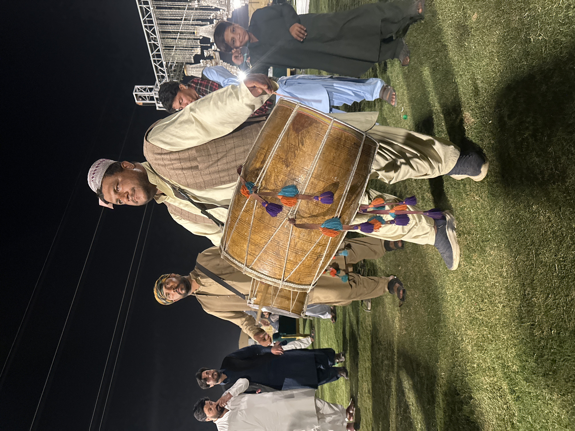 Traditional drumming performance at nighttime outdoor gathering