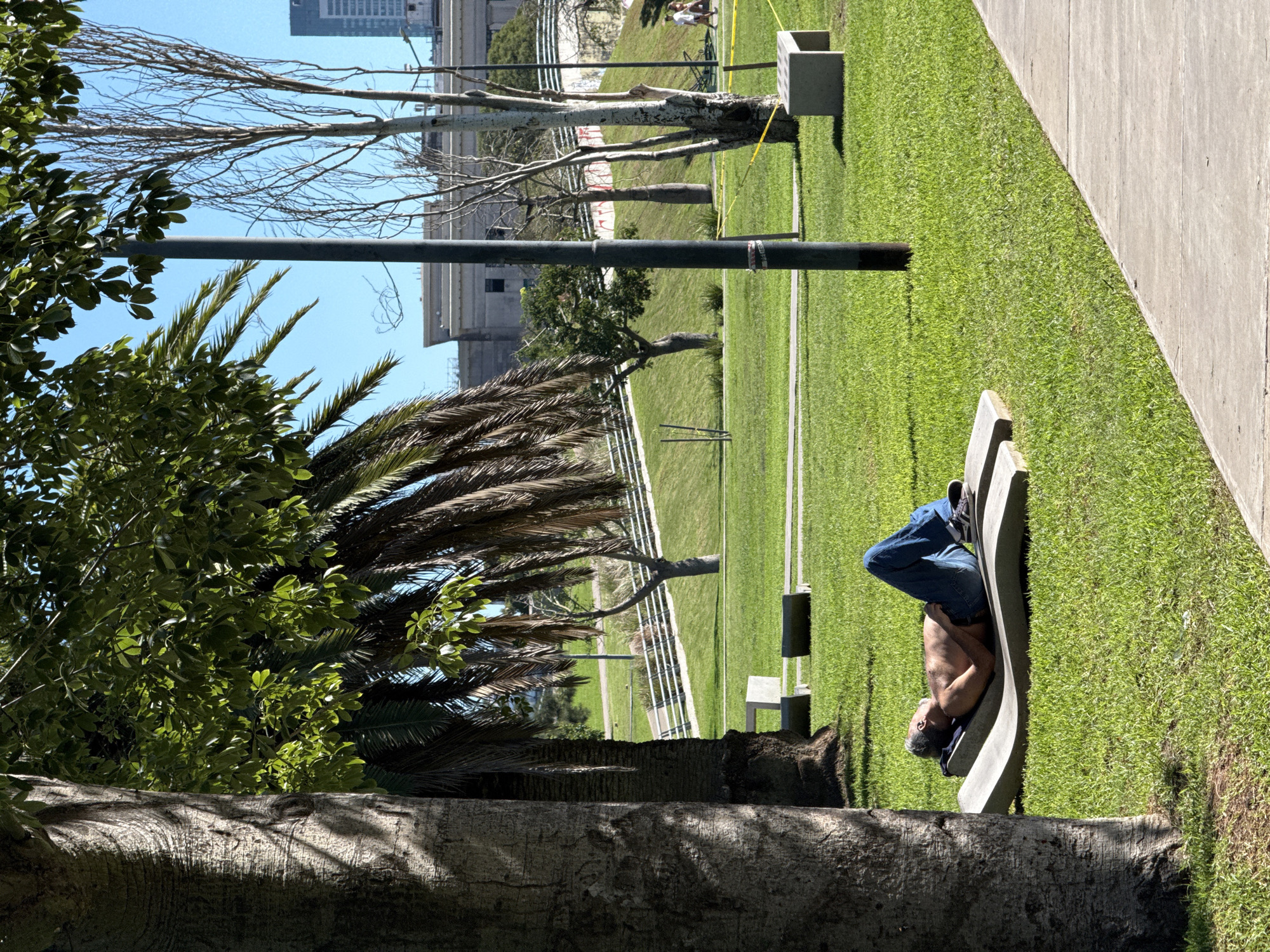 Man rests near bronze sculpture in Buenos Aires park