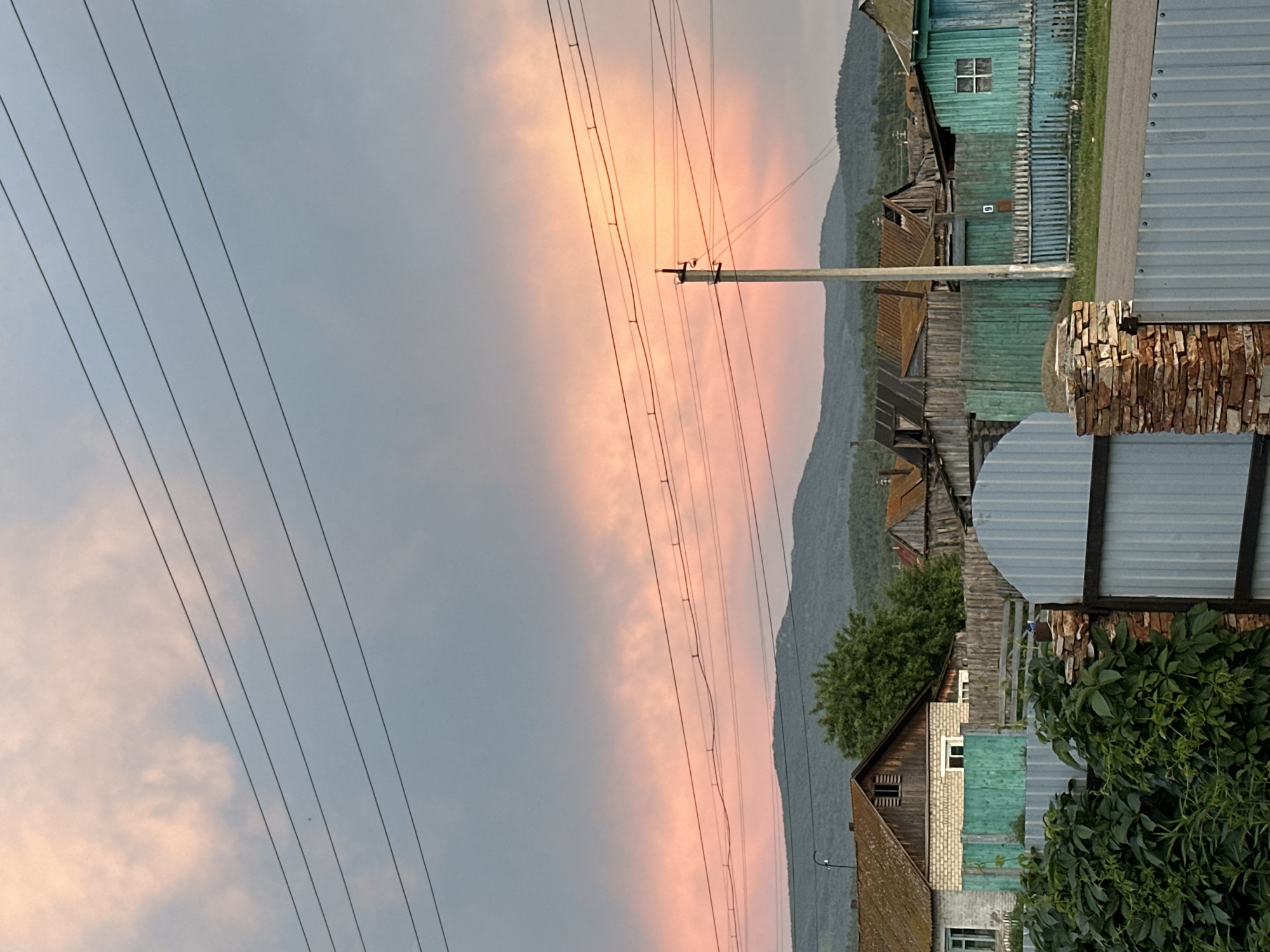 Village evening: kids, livestock, and a vivid sunset sky