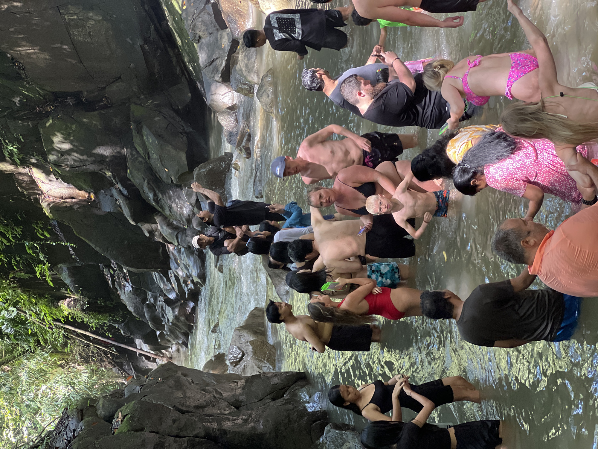 Large group enjoys waterfall swimming in Gianyar jungle