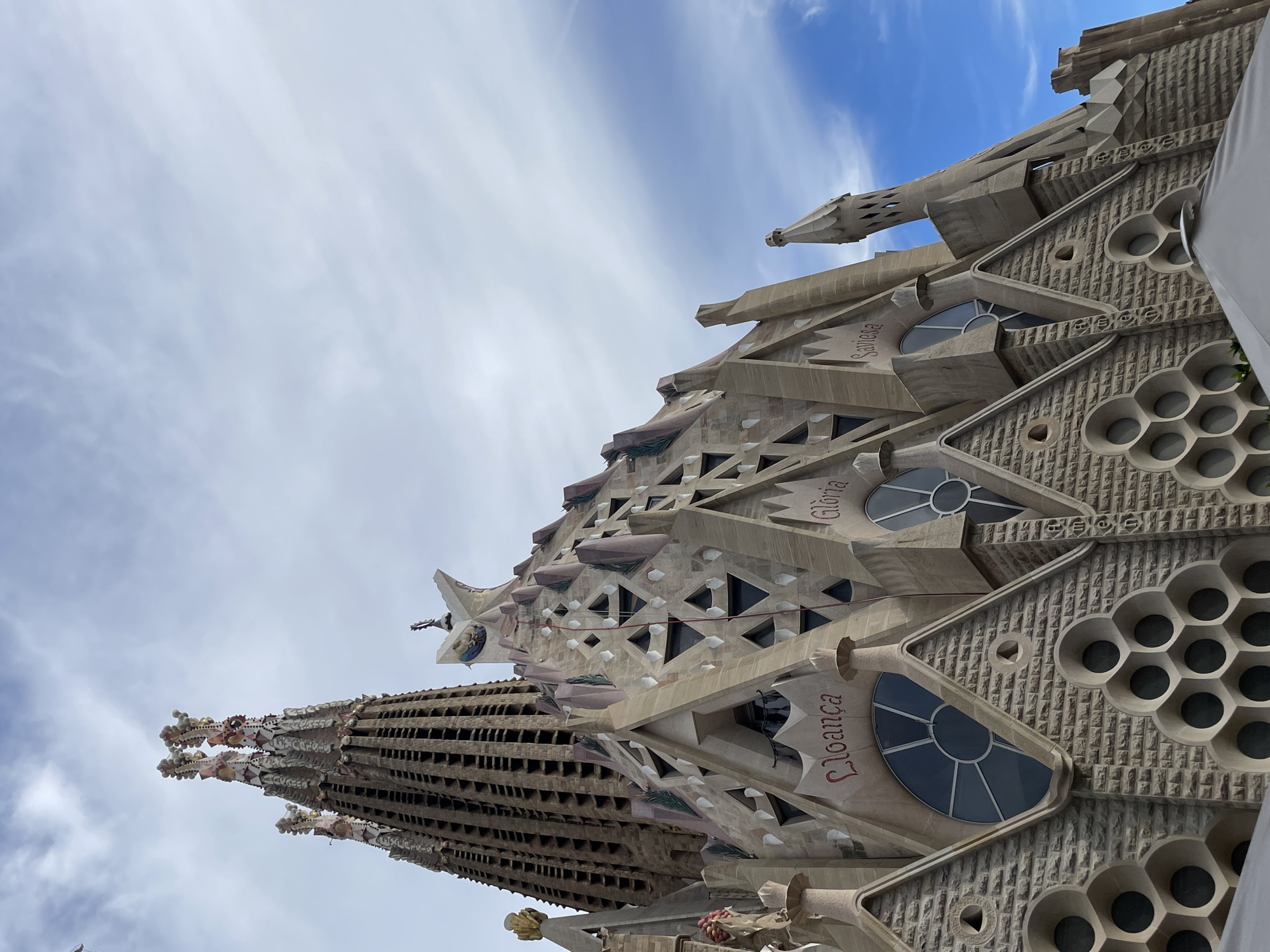 Tourist photographs Sagrada Familia's architectural details in Barcelona