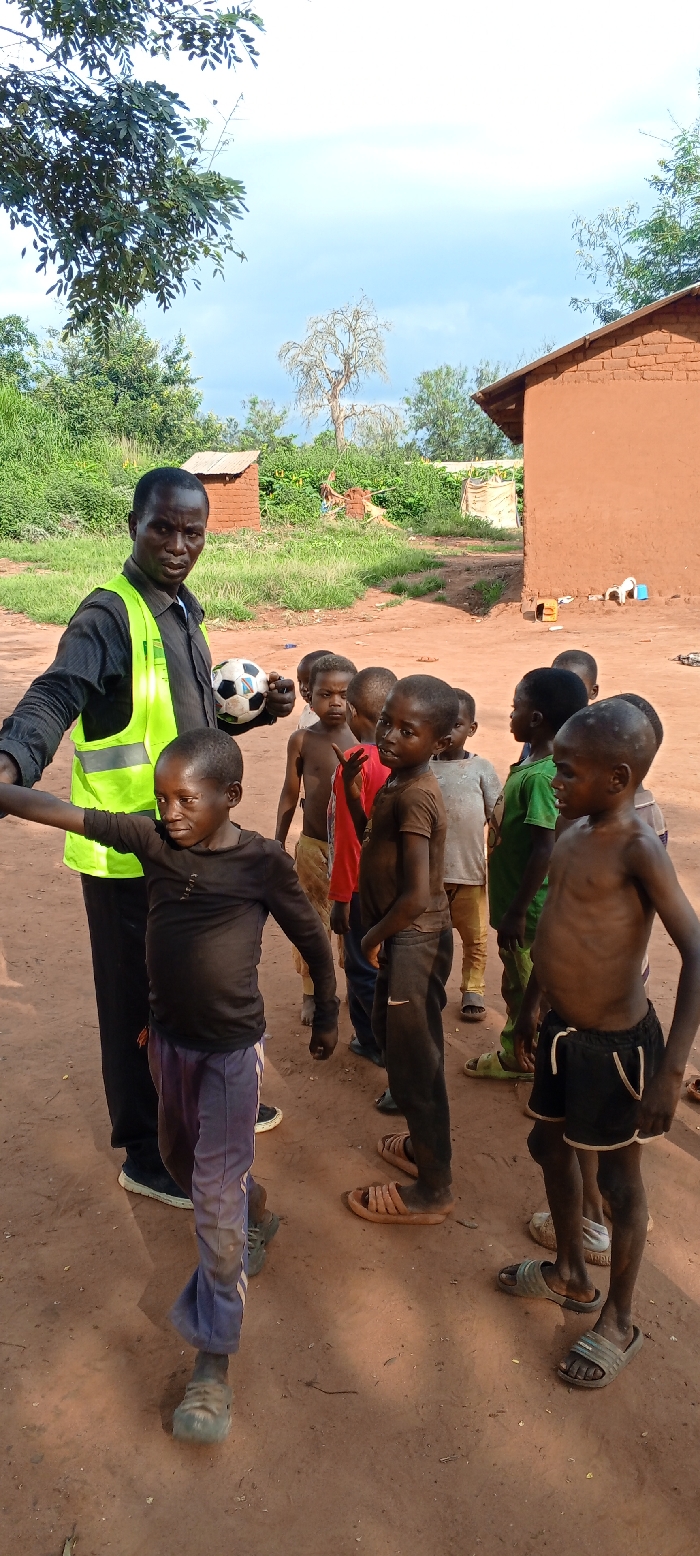 Aid worker distributes supplies to children in Congo villages