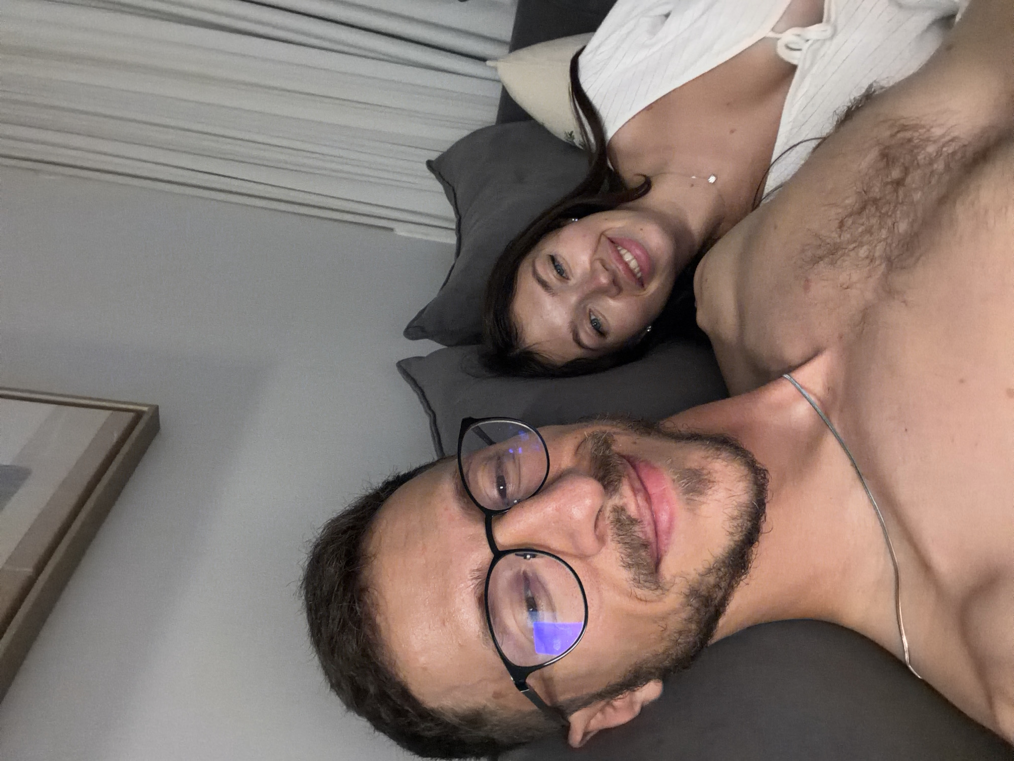 Couple takes selfie on couch in Tel Aviv