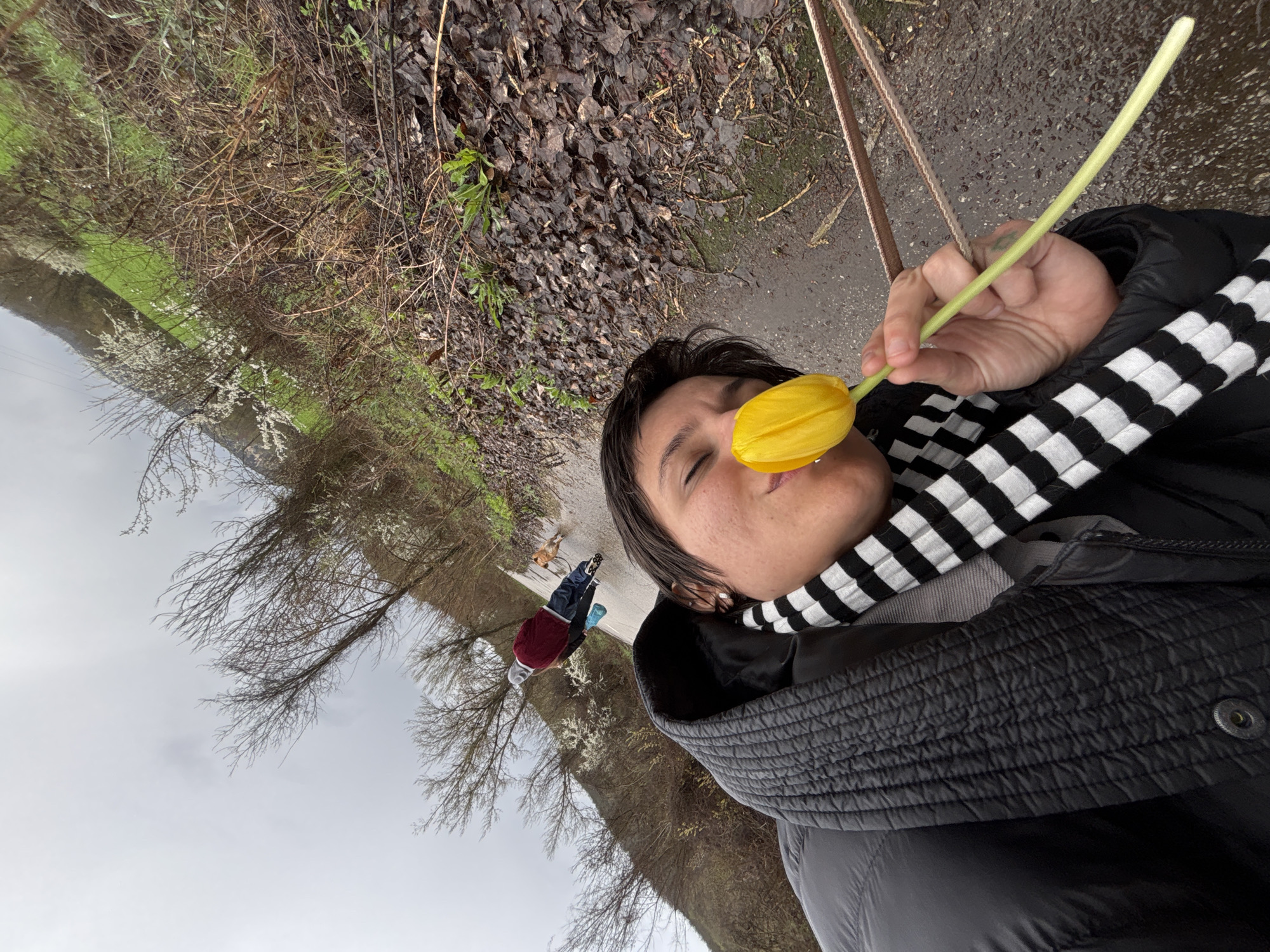 Woman holds yellow tulips during spring walk in Bulgaria