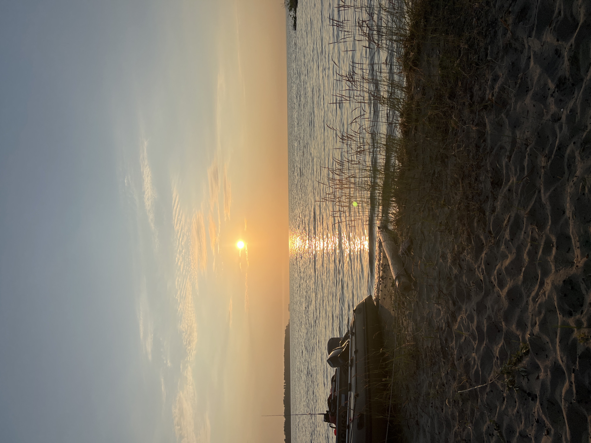 Golden hour at Lake Borovoe, boats ashore at sunset