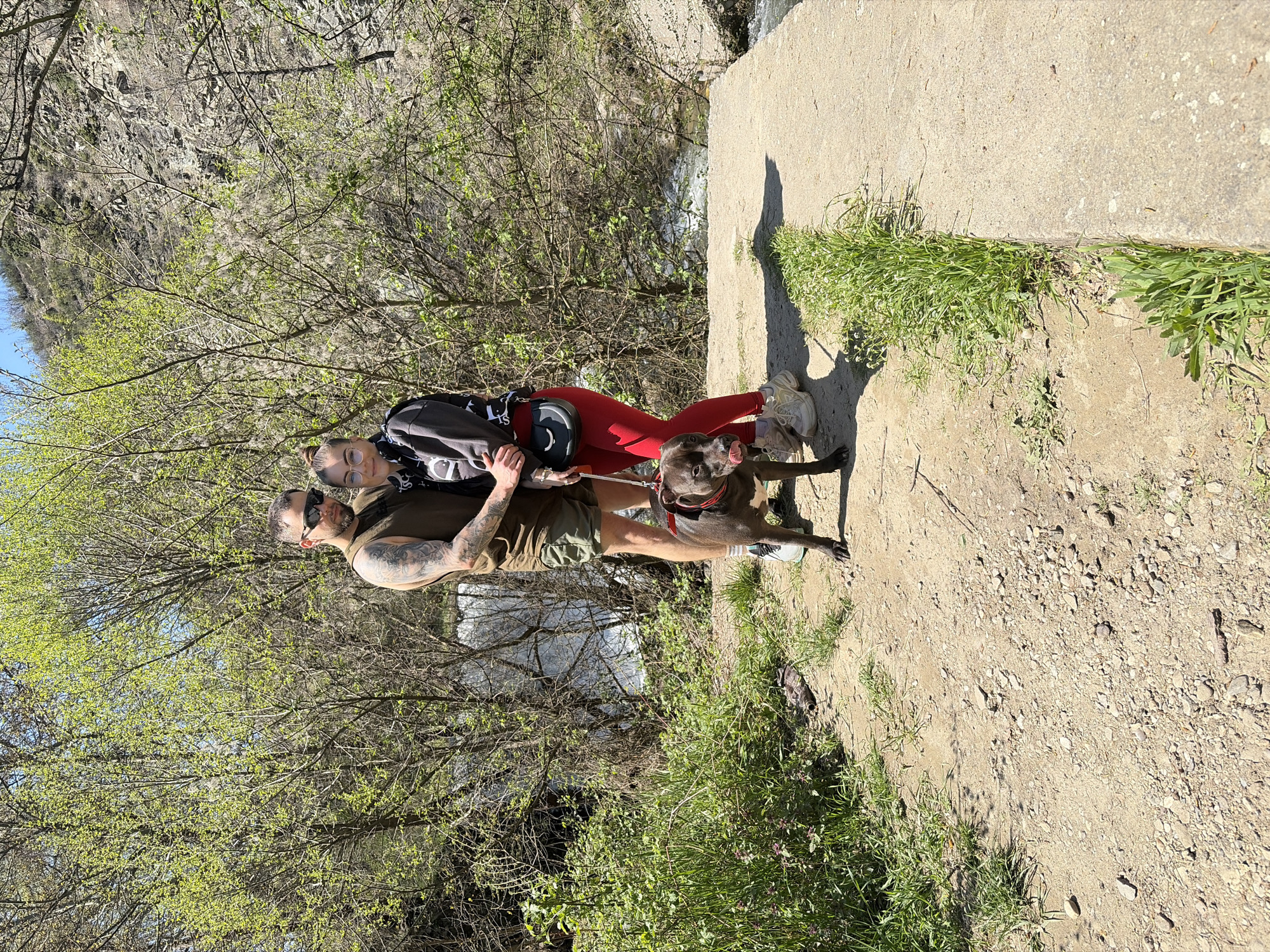 Couple explores scenic ravine area with dog in Parvenets