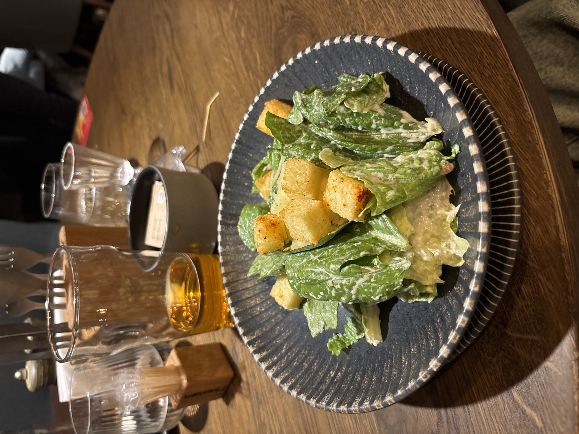 Restaurant worker serves Caesar salad in Engels, Russia