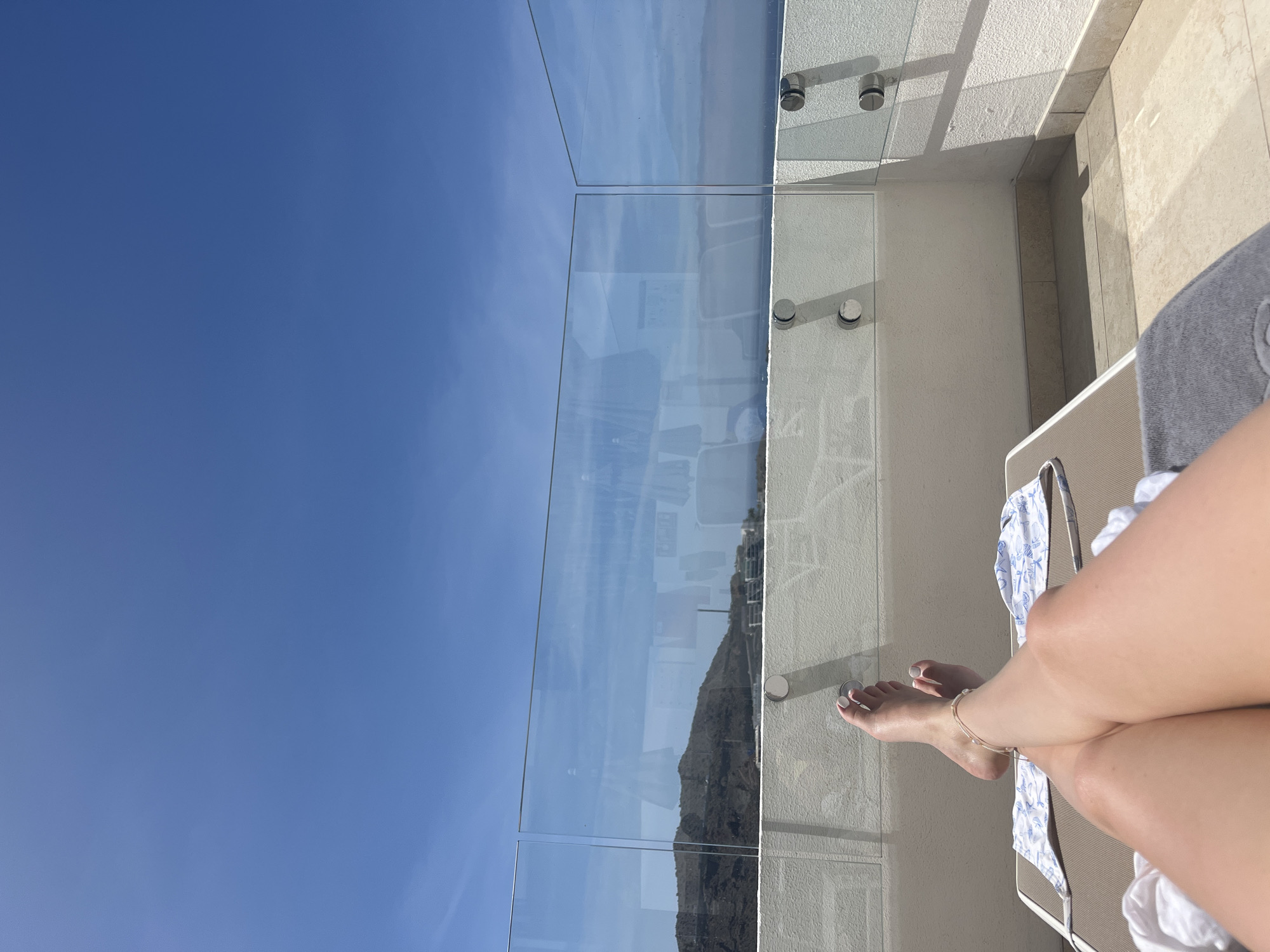 Person relaxes on ocean-view balcony in Puerto Rico, Spain