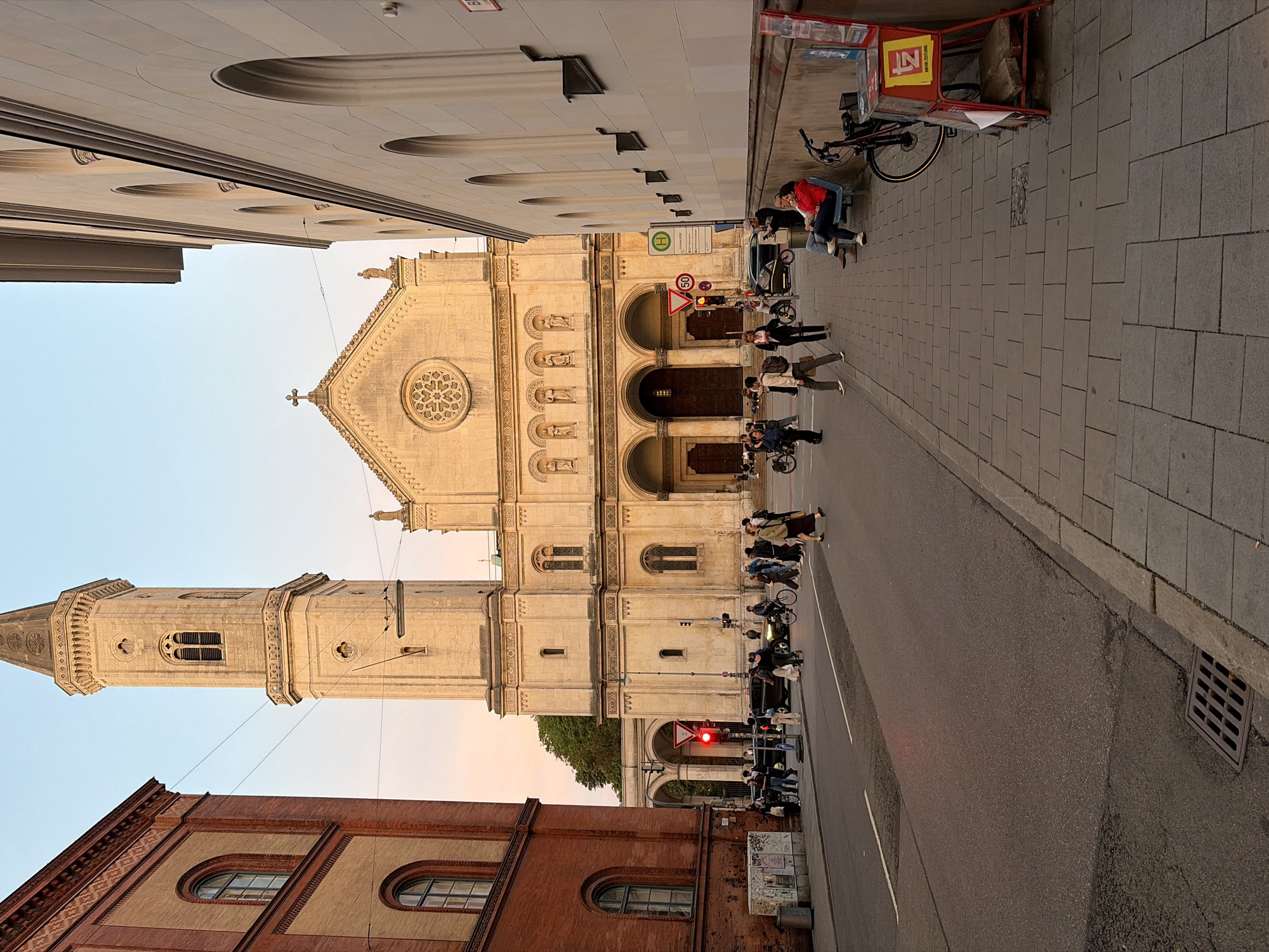 Munich street at golden hour, church and city buildings