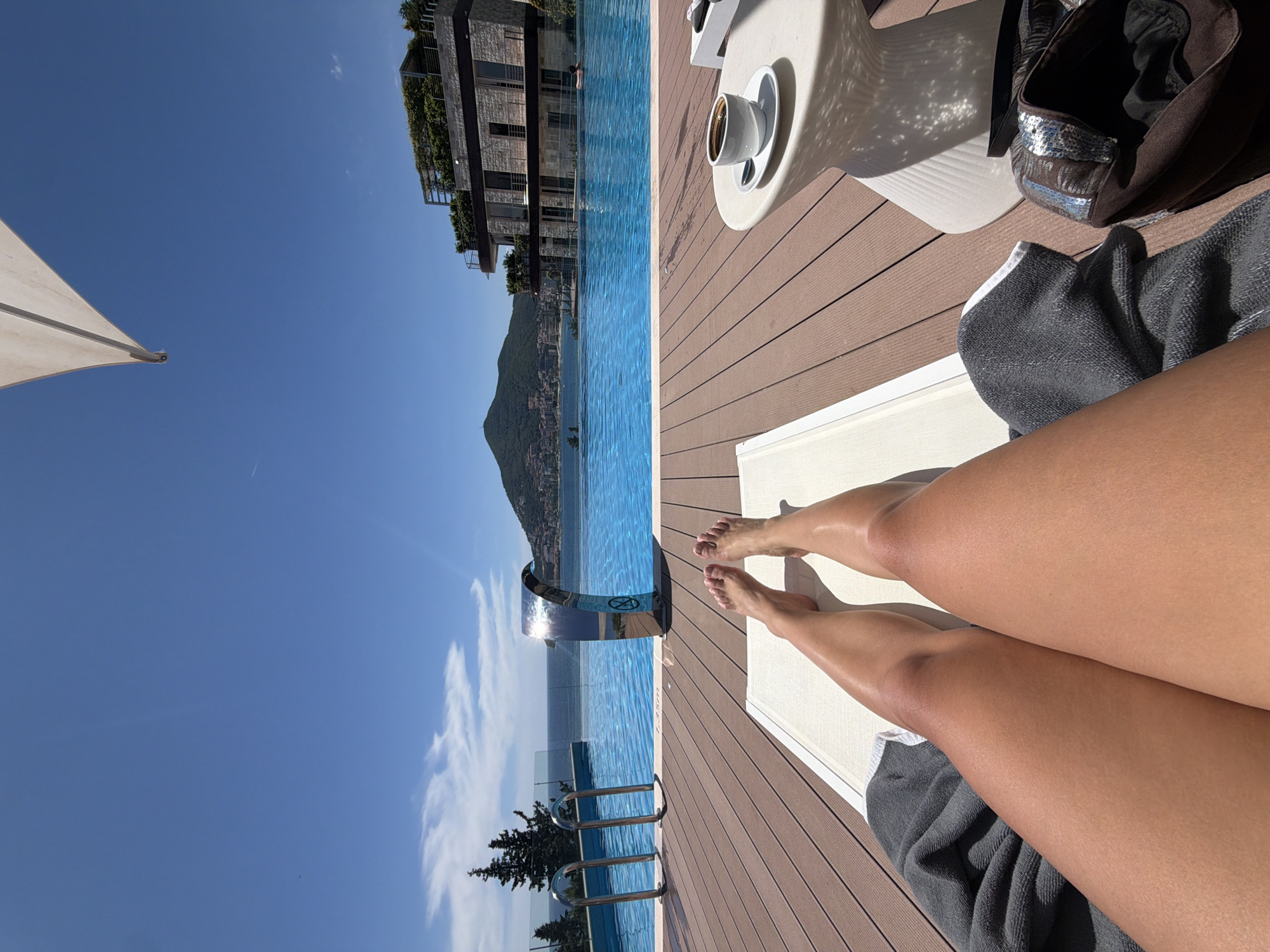 Poolside relaxation at Budva infinity pool overlooking Adriatic Sea