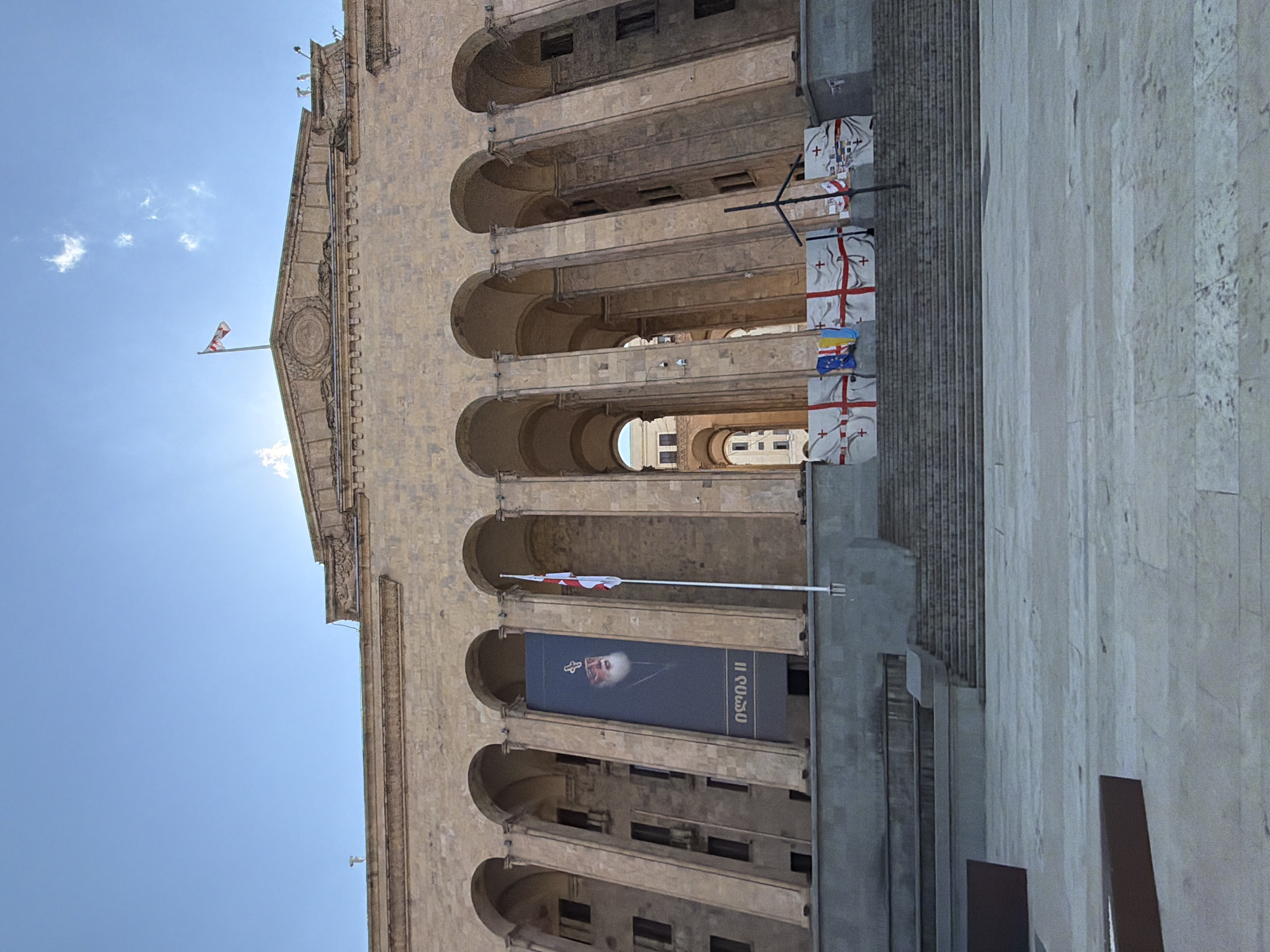 Person sits outside Georgian government building in Tbilisi