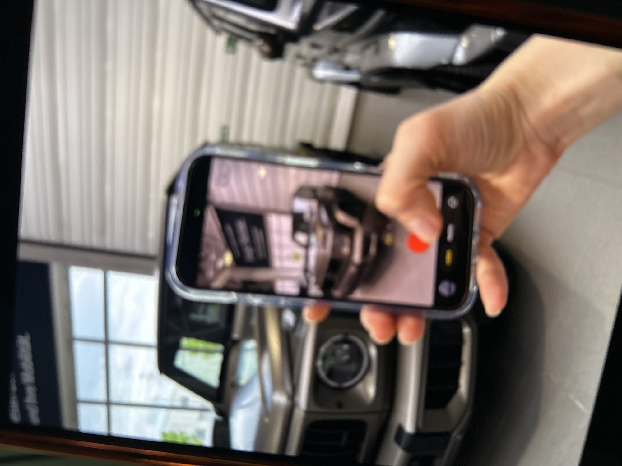 Person photographs Mercedes G-Class at German dealership