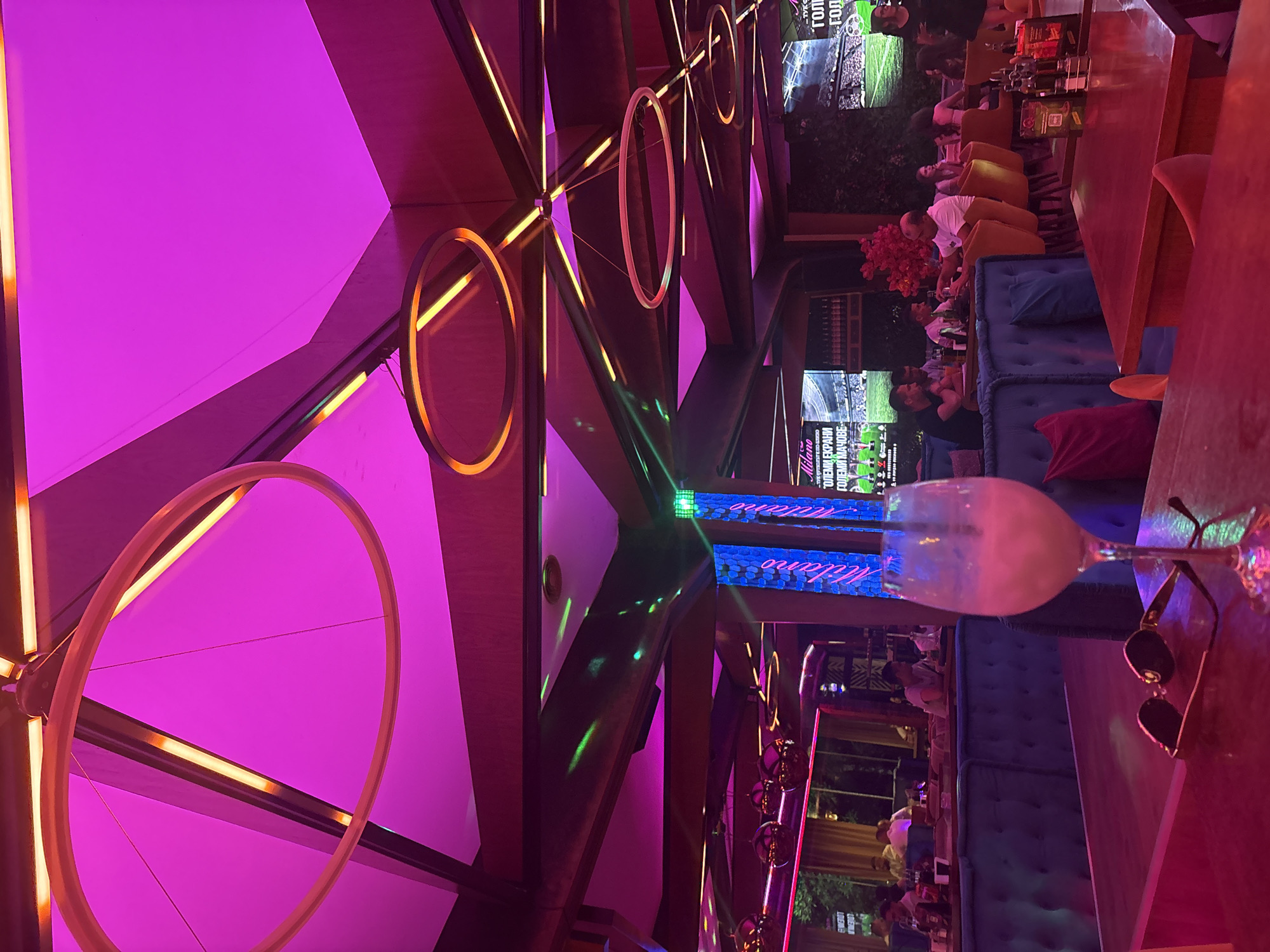 Evening nightclub interior documented with vibrant neon lighting displays