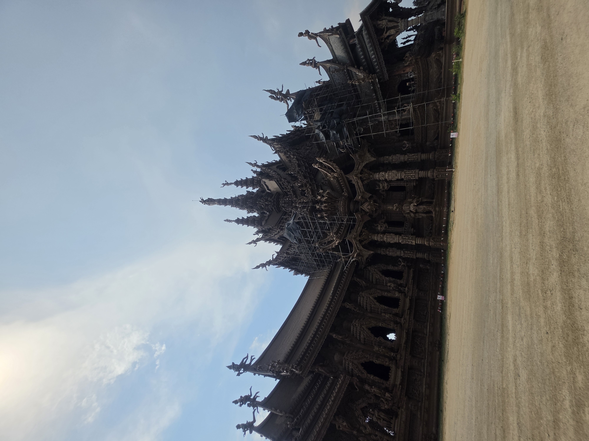 Tourist documents Pattaya's Sanctuary of Truth temple and artisan workshops