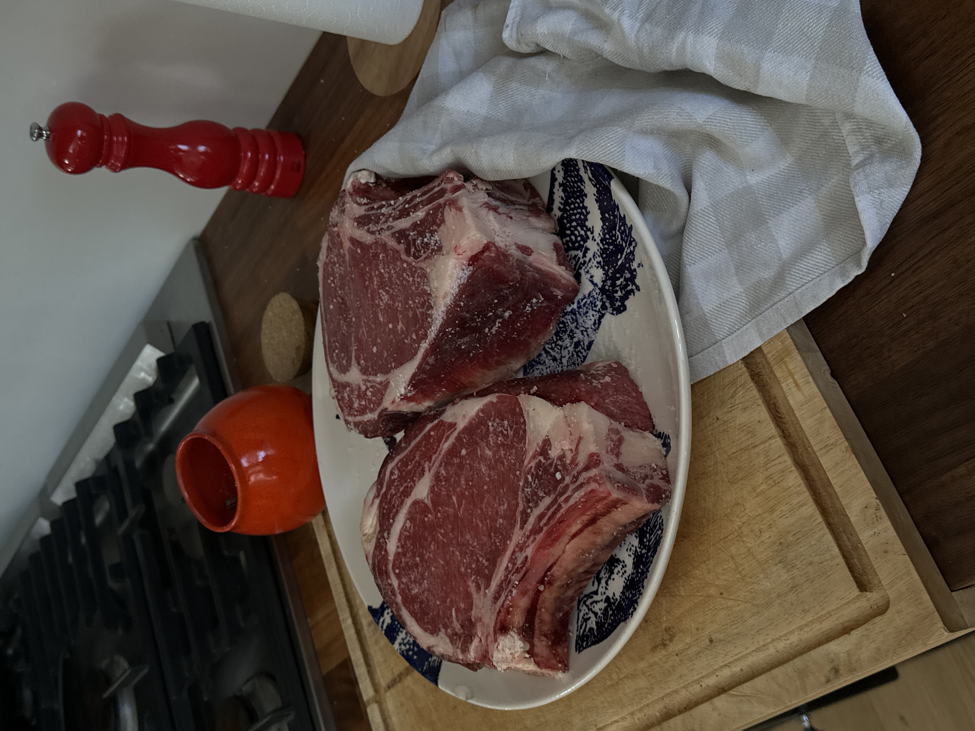 Seasoned ribeye steaks prepared for cooking in French coastal town