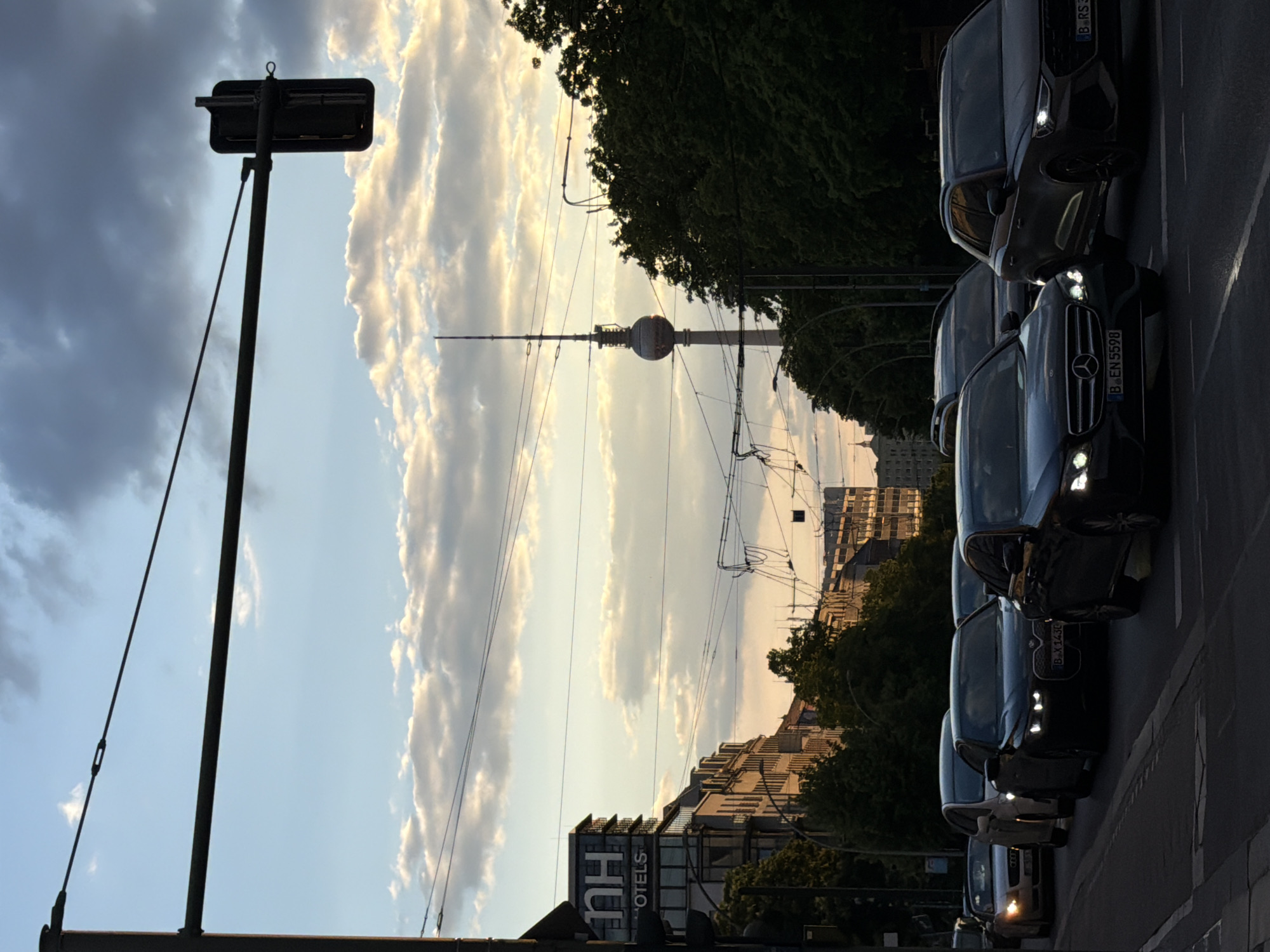 Berlin street scene captures TV Tower at sunset