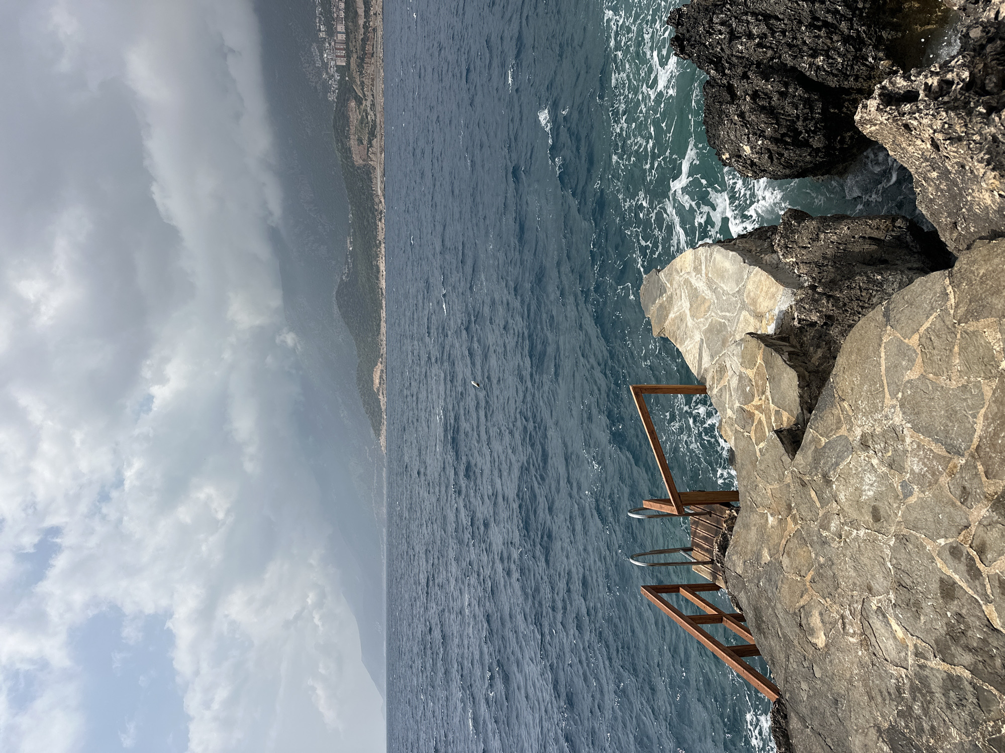 Empty beach furniture awaits visitors at Kaş coastal terrace