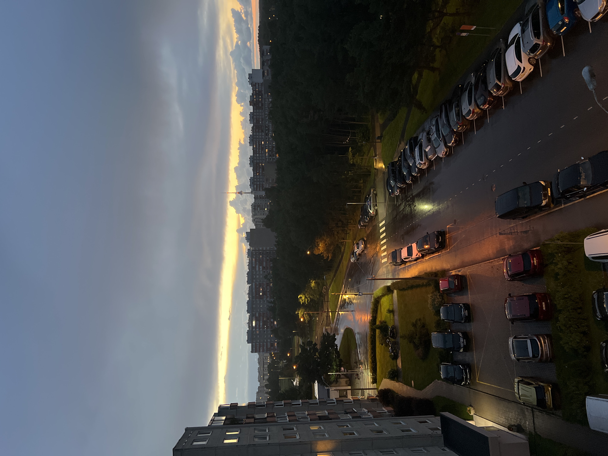 Tallinn residential district glows under a moody summer dusk sky