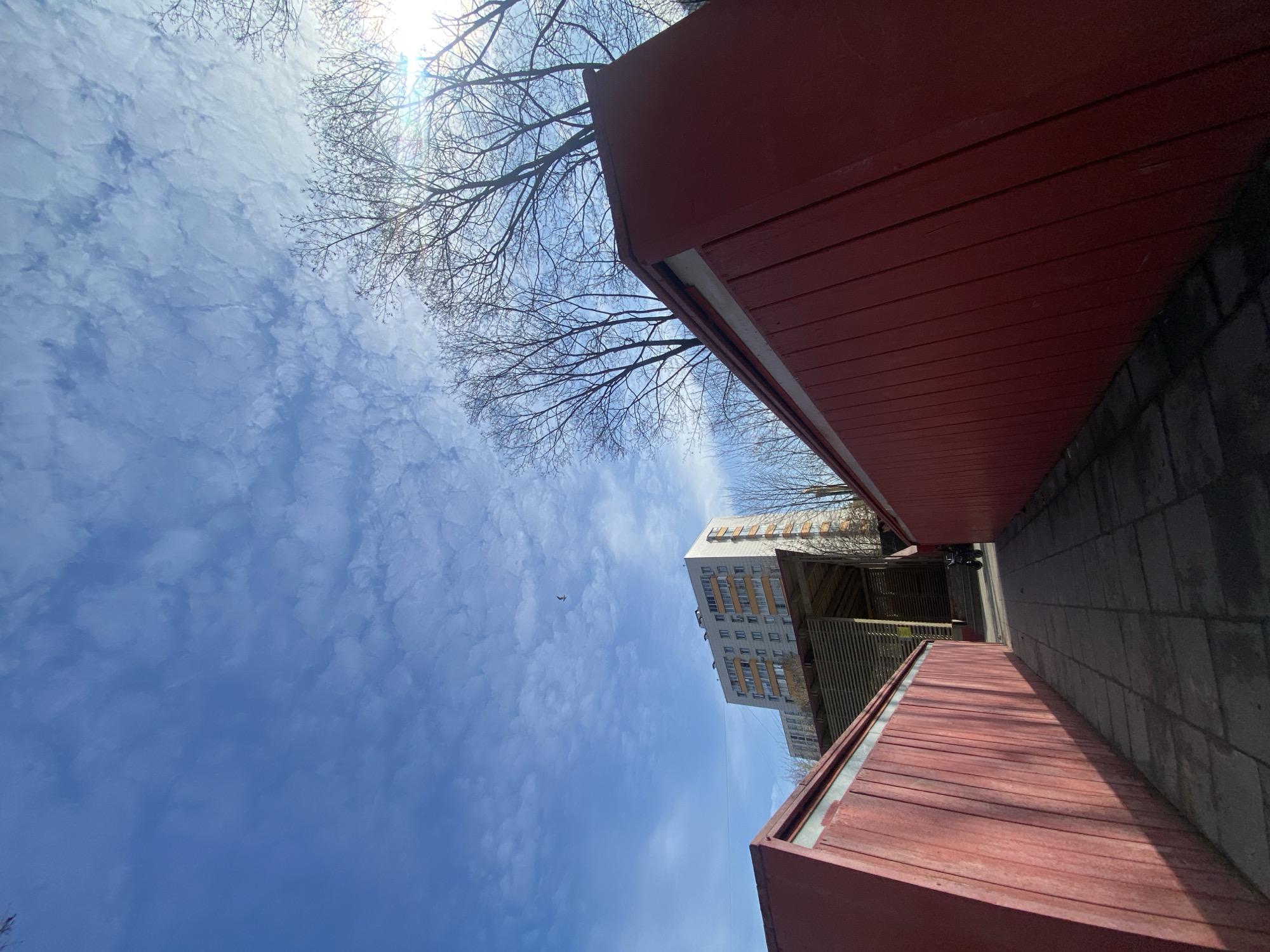 Spring morning sky observed between red buildings in Khimki