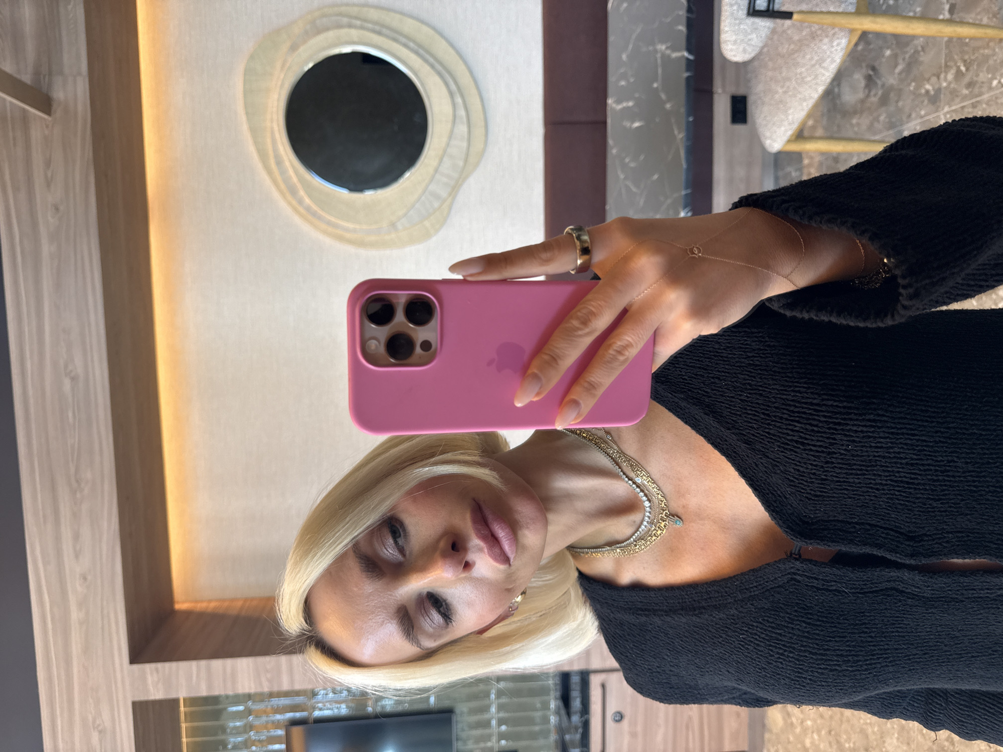 Woman takes mirror selfies with pink iPhone in San Diego