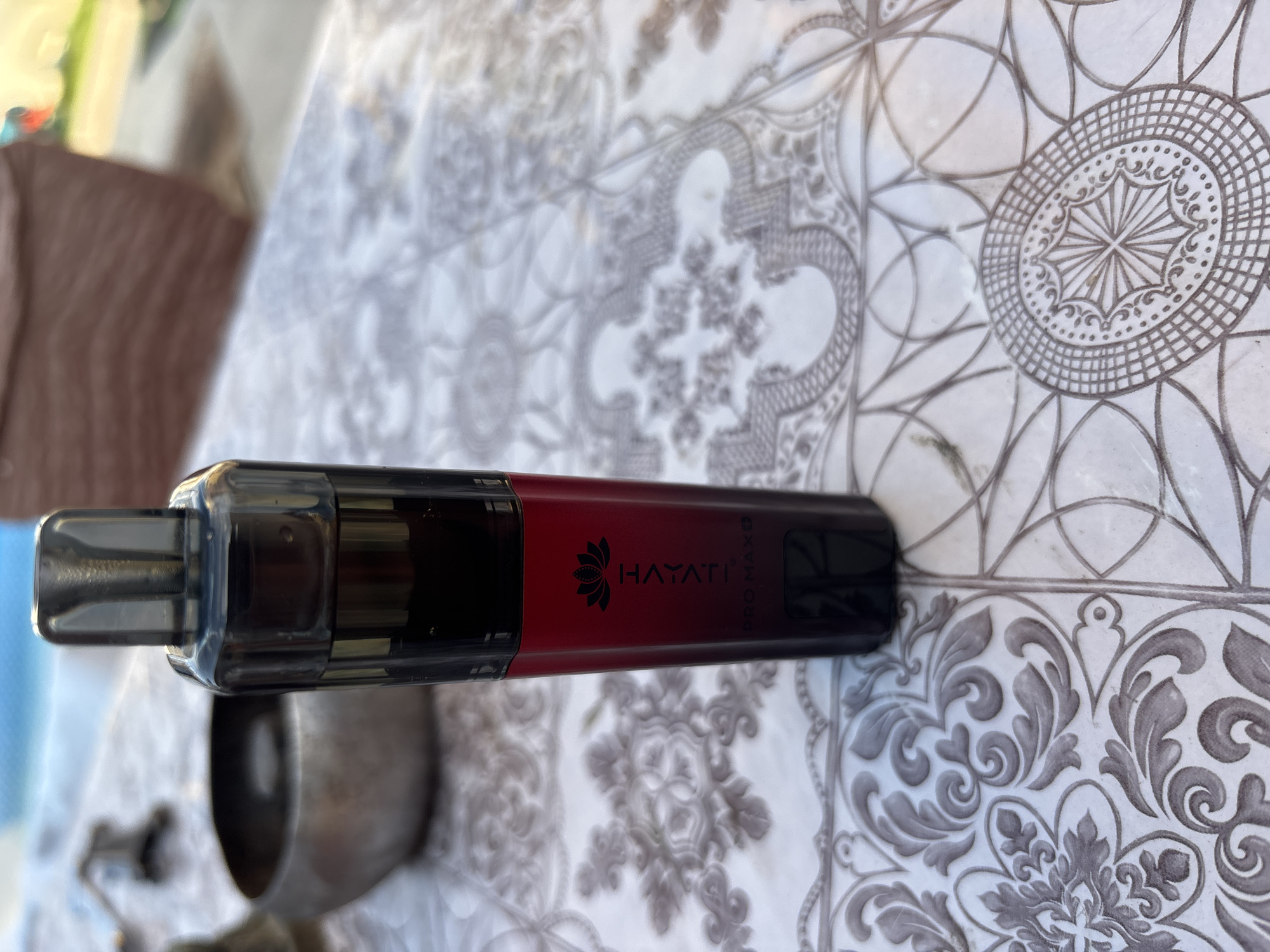 Hayati Pro Max vape on a patterned tablecloth, Dupnitsa
