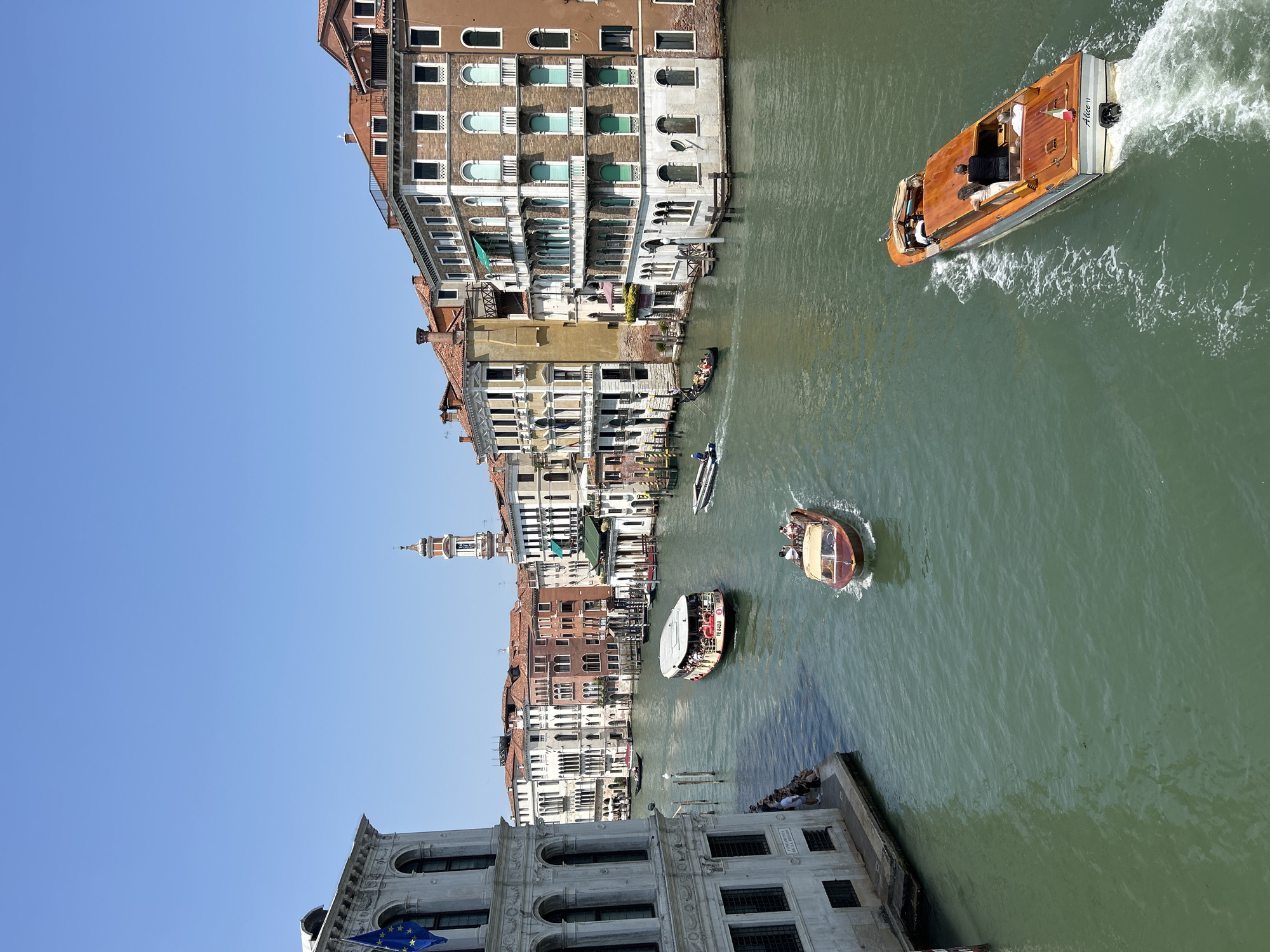 Overhead view of a Venetian canal and historic waterfront buildings.