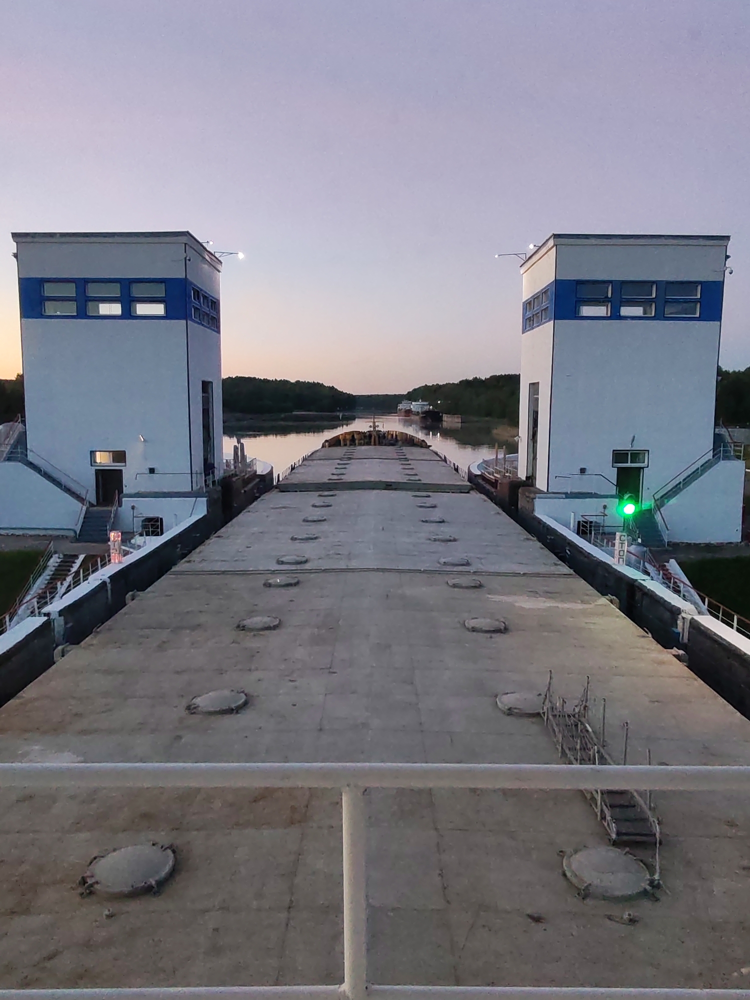 Vessel transits canal lock system during twilight operations